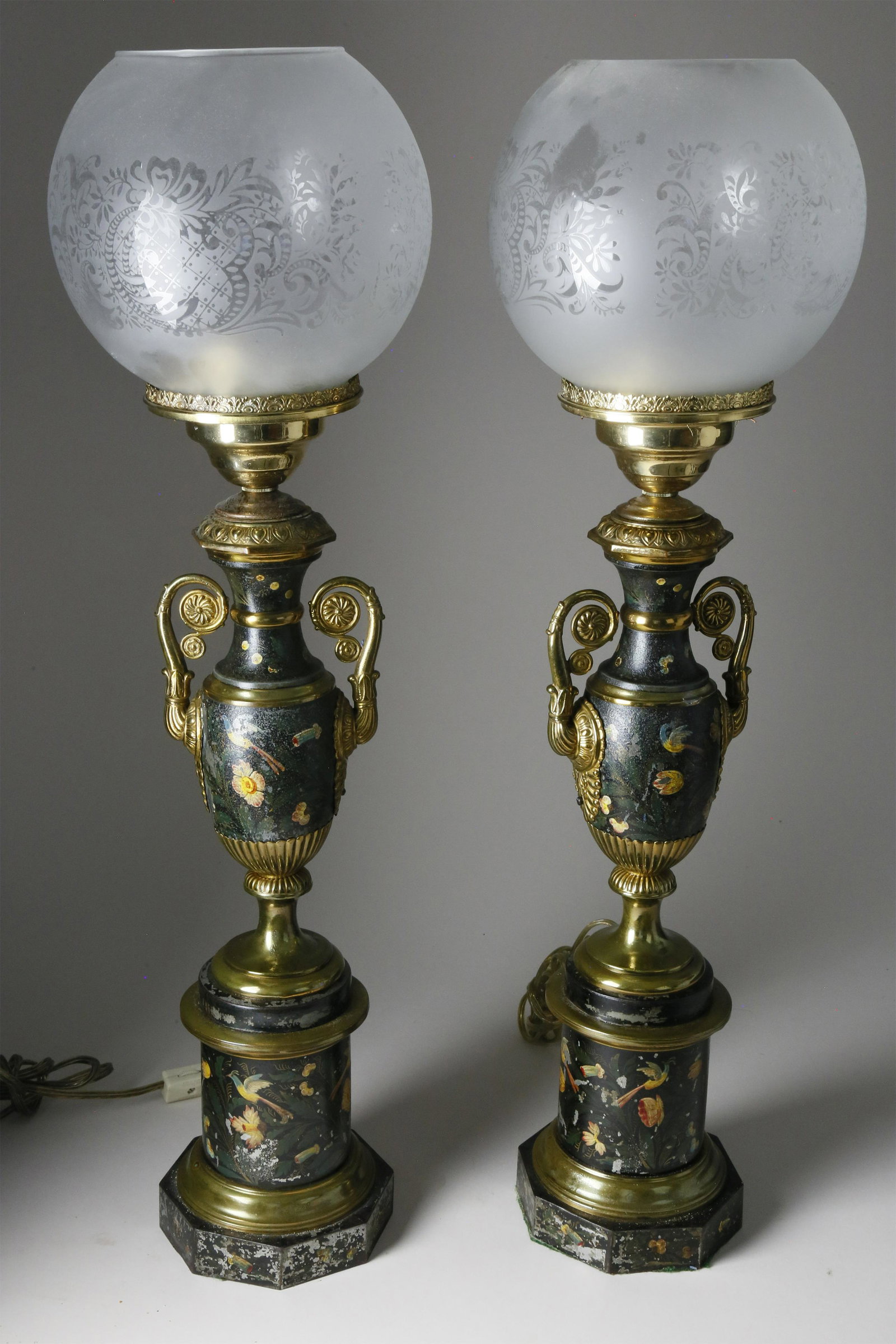 Pr of French Tole Peinte Parlour Lamps, late 19th c.: Pair of French Tole Peinte Parlour Lamps, late 19th Century, baluster standard painted in polychrome with birds and flowers; gilt metal neoclassical mounts. Drum-form base with octagonal foot; etched