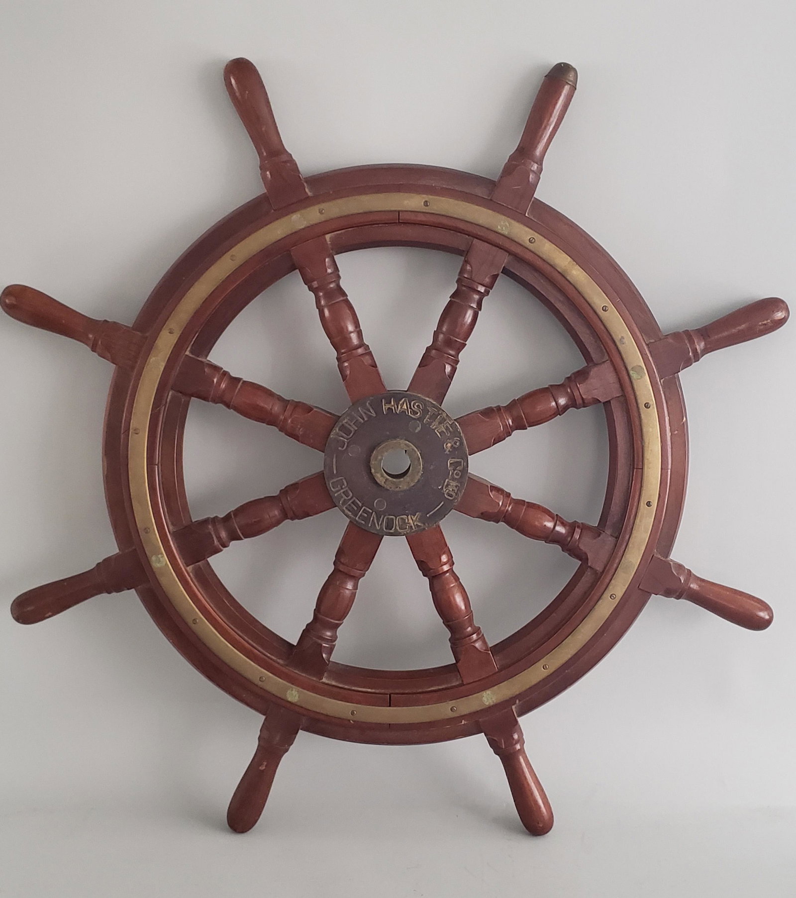 John Hastie & Co. Mahogany and Brass Ships Wheel: 19th Century Mahogany and Brass Ship's Wheel John Hastie & Co. Ltd. Greenock, Scotland, eight-spoke ship's wheel with a brass hub and support rails around the wheel, with turned mahogany spokes and ha