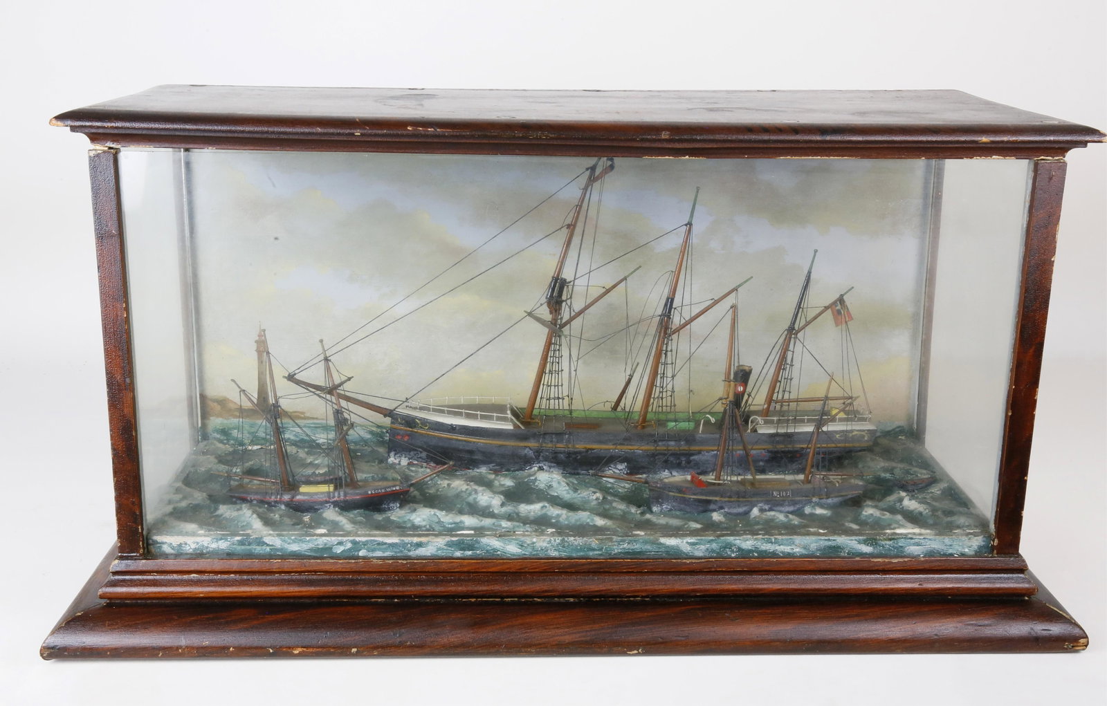 Diorama of Shipping Off the Coast of Victoria: Diorama of Shipping Off the Coast of Victoria, Australia, late 19th Century, carved and painted wood with mixed media in a glazed grained wood case. A representation of the 1862 Gabo Island Lighthouse