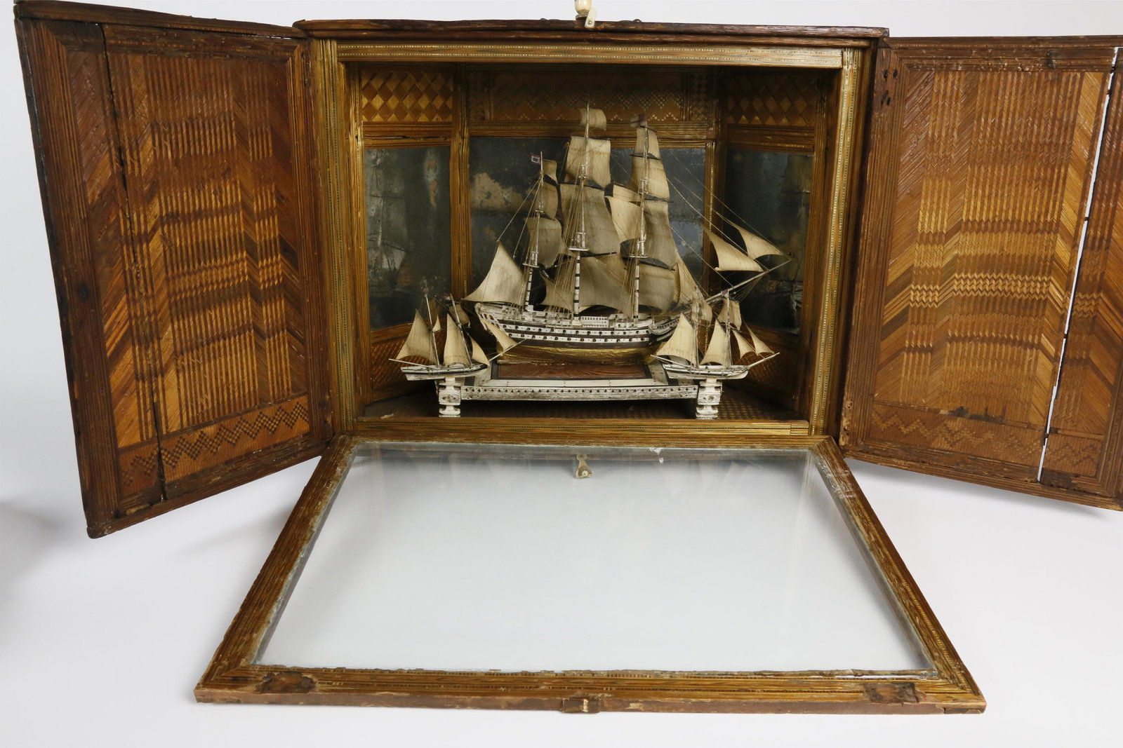 French Prisoner of War Bone Ship Model in Straw Case: French Prisoner of War Bone Ship Model in a Straw Marquetry and Parquetry Case, 18th Century, fine detailed fully outfitted 60-gun ship-of-the-line. Carved female figurehead and baleen, bone and brass