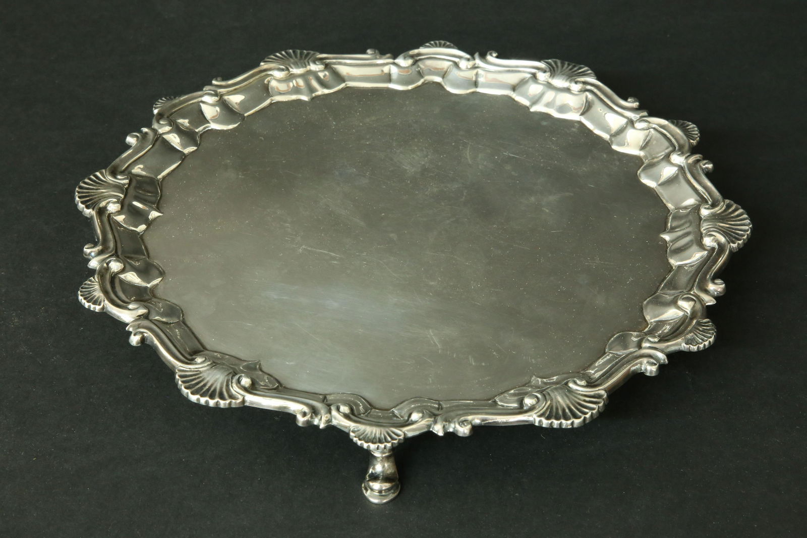 George II Sterling Silver Salver, William and Robert Peaston, London, 1758: George II Sterling Silver Salver, William and Robert Peaston, London, 1758, shaped circular form with shell and scroll border , on three stylized hoof feet Diameter 9.75 in. Weight : 12.6 troy oz
