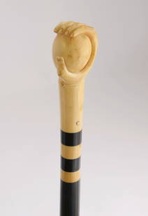 Whaleman Carved Antique Whale Ivory Hand Grasping a Ball Walking Stick, 19th Century: Whaleman Carved Antique Whale Ivory Hand Grasping a Ball Walking Stick, 19th Century, with two ebony spacers on tapering ebony shaft ending in 2.5 inch horn ferrule Length 34.25 in.