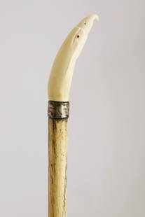 Whaleman Carved Eagle Head Walking Stick, circa 1860: Whaleman Carved Eagle Head Walking Stick, circa 1860, the head inlaid with sterling nares and collar, on a whalebone tapering shaft Length 36 in.