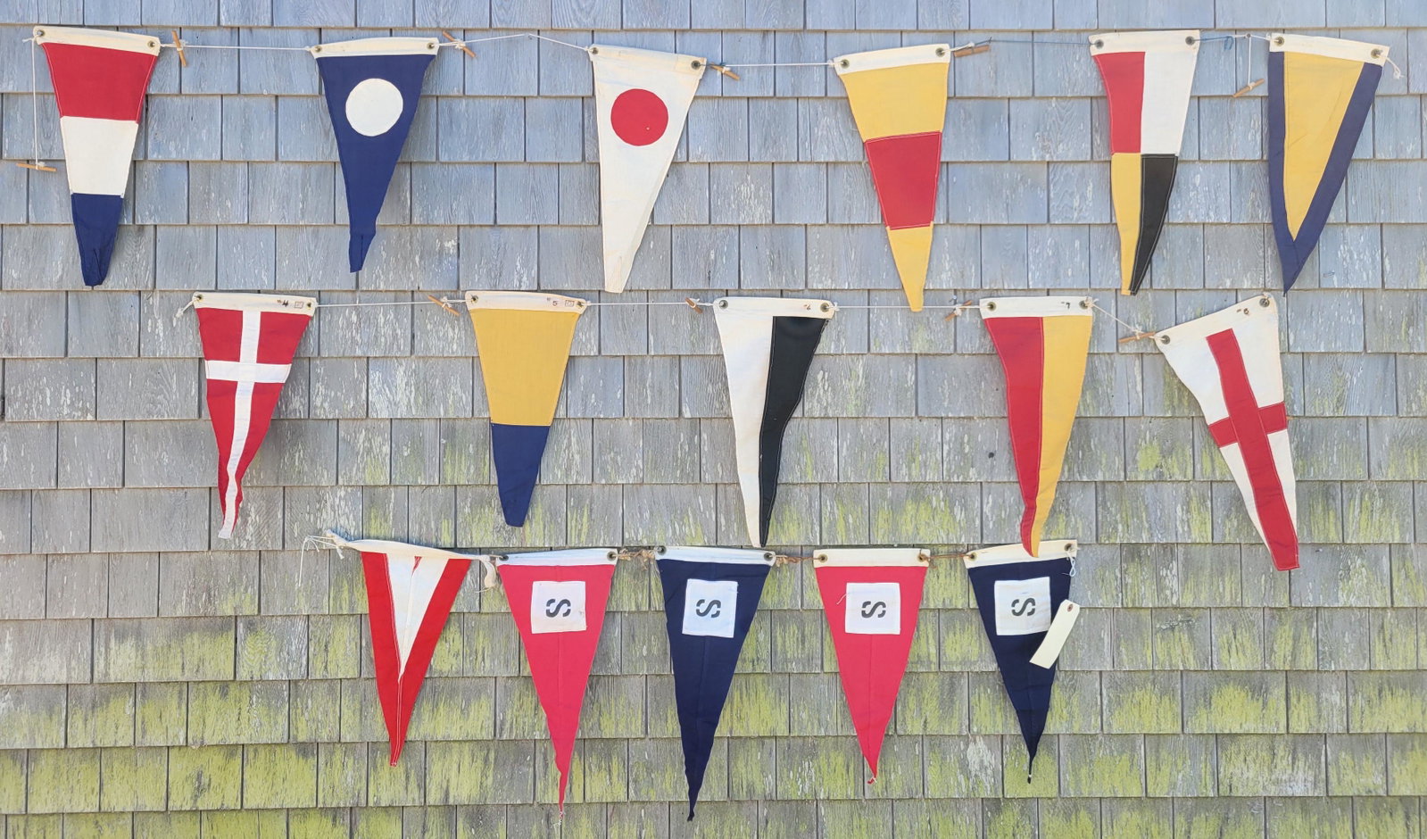 Group of 16 Vintage 1930s Nautical Signal Flag Pennants: Group of 16 Vintage 1930s Nautical Signal Flag Pennants, cotton with brass grommets and wooden connecting toggles, unusual small size size Widths 8 in. Lengths 18 in.
