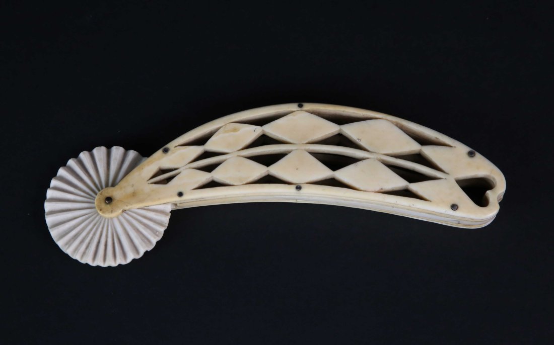 Whaleman Made Pie Crimper, circa 1850: Whaleman Made Pie Crimper, circa 1850, carved from an antique sperm whale tooth; solid zigzag wheel pinned to an open-work diamond chain, handle ending in a heart Length 6.5 in.