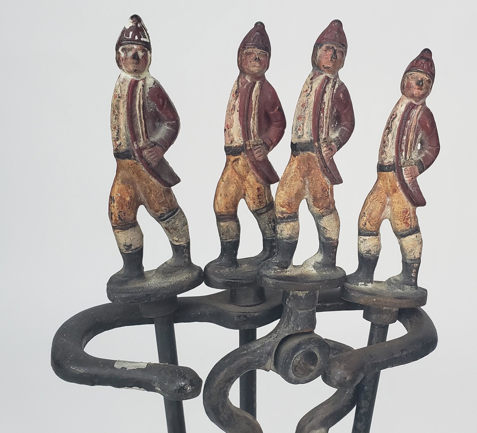 Antique Four-Piece Cast Iron Figural Hessian Fire Tool Set: Antique Four-Piece Cast Iron Figural Hessian Fire Tool Set, consisting of stand, shovel, poker, and tongs. Height Overall 30.5 in.