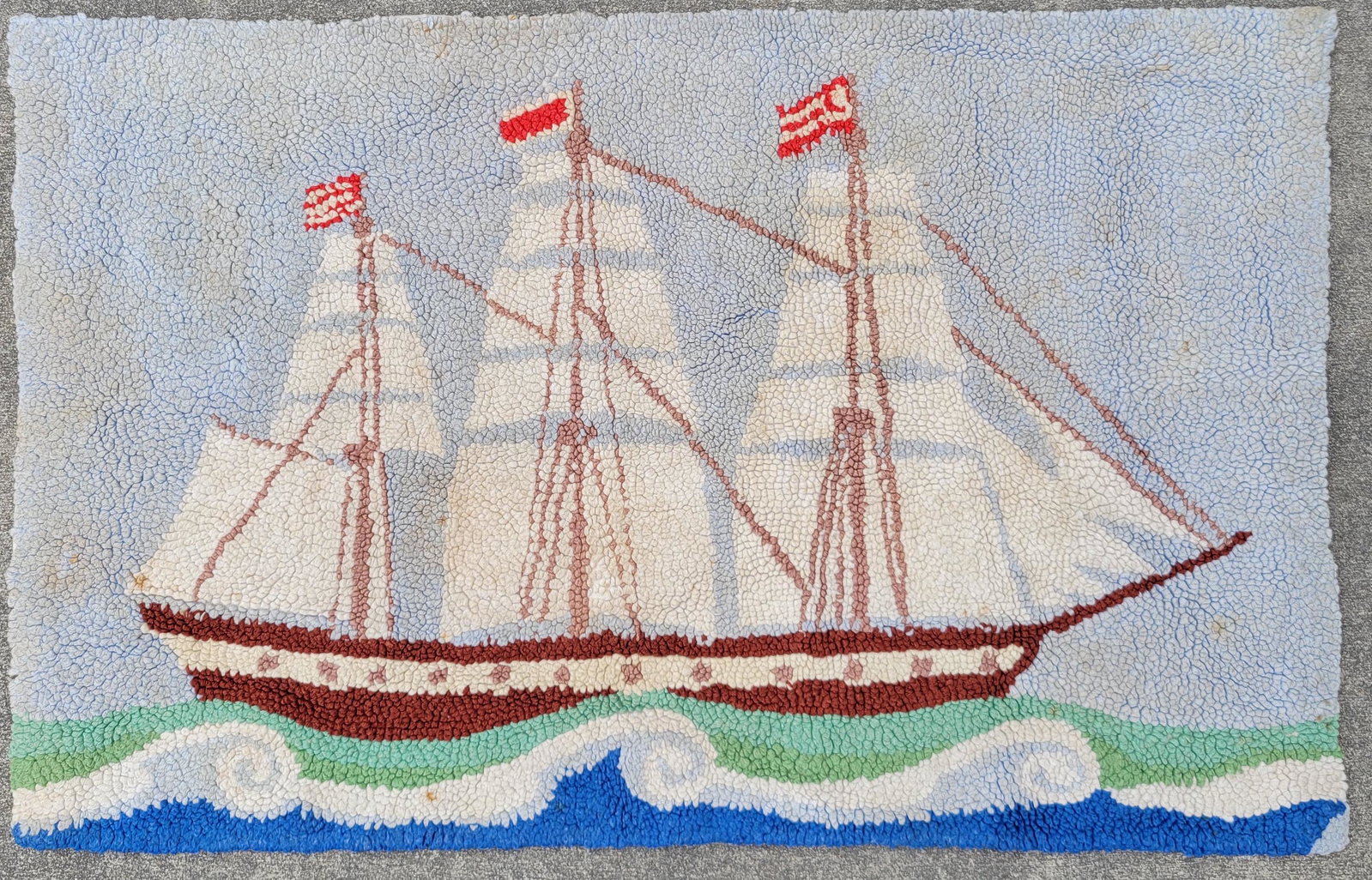Vintage American Folk Art Nautical Three Masted Ship Hooked Rug: Vintage American Folk Art Nautical Three Masted Ship Hooked Rug, at full sail flying flags from each mast. 22 in. x 34.5 in.