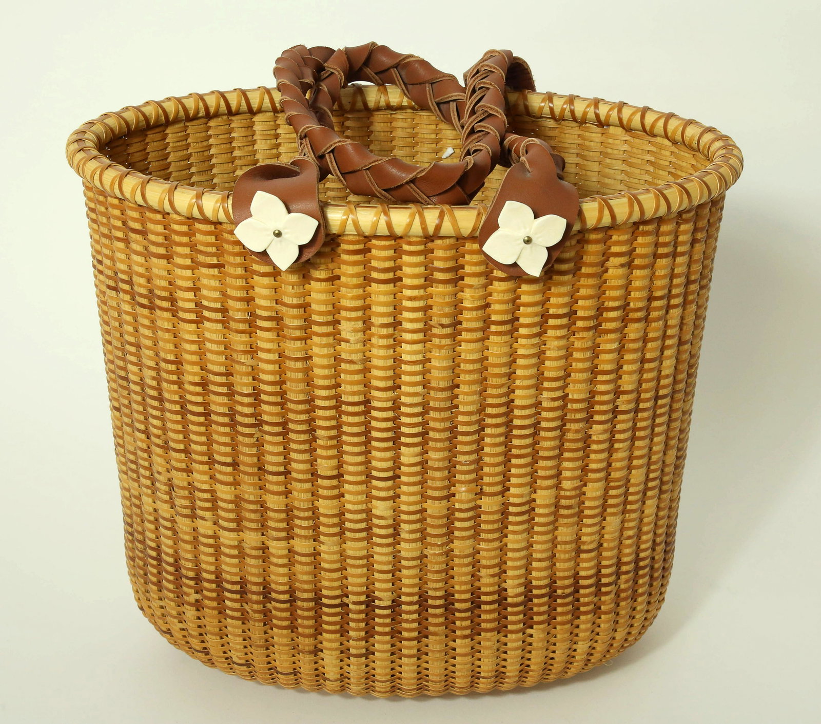 Judi Heustein Nantucket Basket, circa 2000: Judi Heustein Nantucket Basket, circa 2000, deep oval with platted leather handles adorned with rosettes; underside with dedicatory inscription; signed and dated "With Love, Judi Heustein, 2001" Heigh