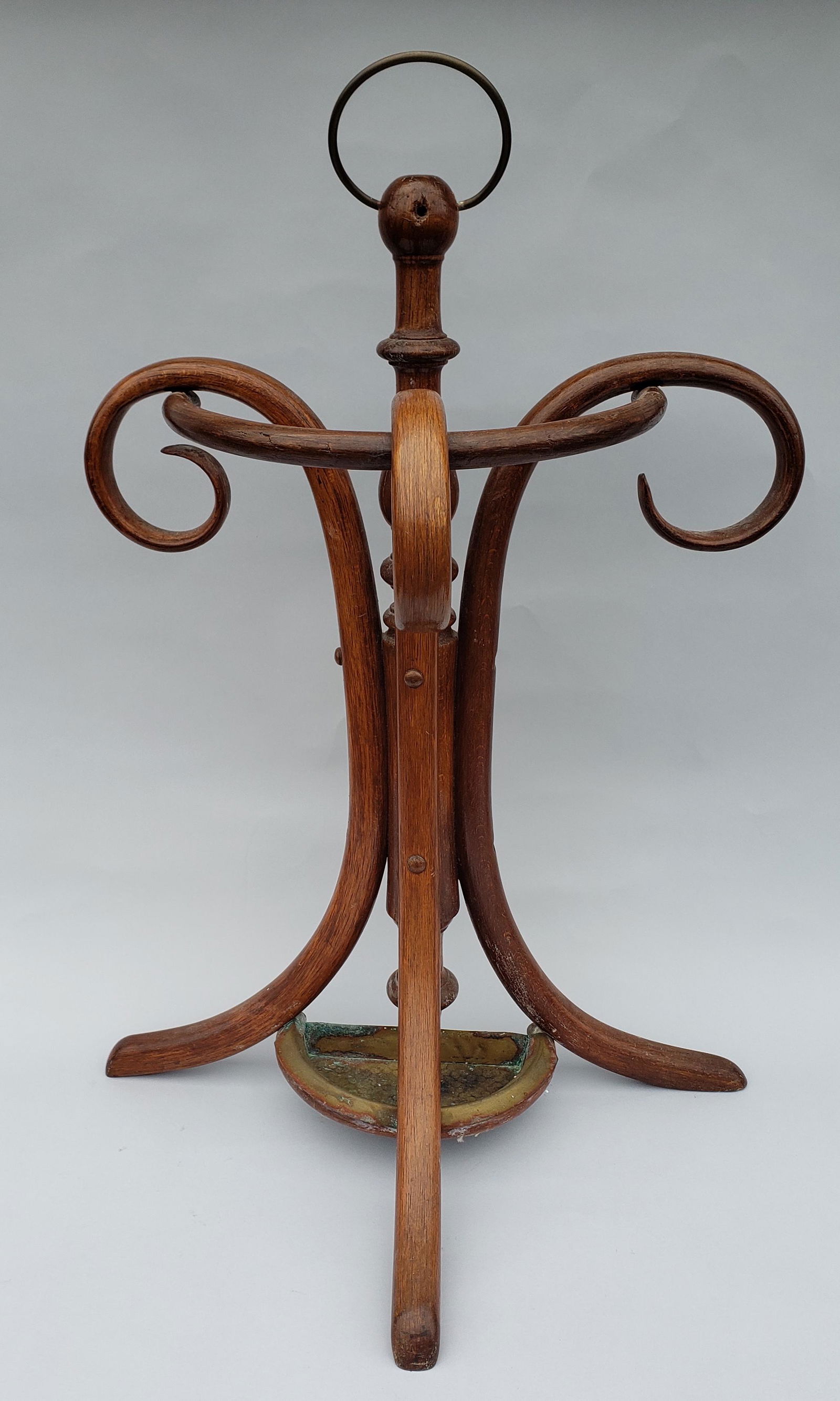 Antique Thonet Bentwood Umbrella Stand, 19th Century: Antique Thonet Bentwood Umbrella Stand, 19th Century, with hammered brass drip pan. Height 34 in Width 23.25 in. Depth 13 in.