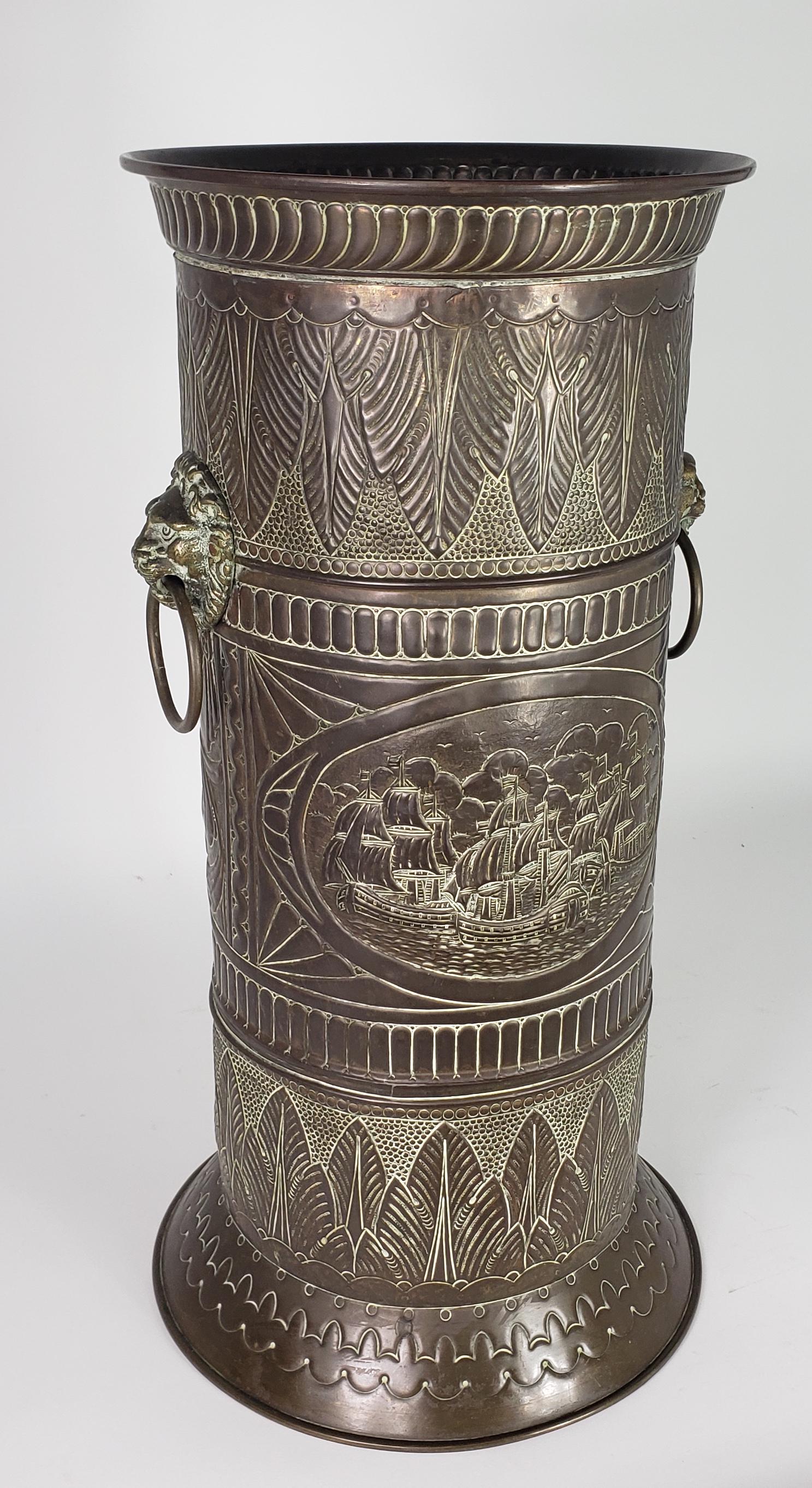 Antique Brass Ship and Lion's Head Umbrella Holder Stand: Antique Brass Ship and Lion's Head Umbrella Holder Stand, with profuse embossed decoration throughout. Height 24 in. Width 12.5 in.