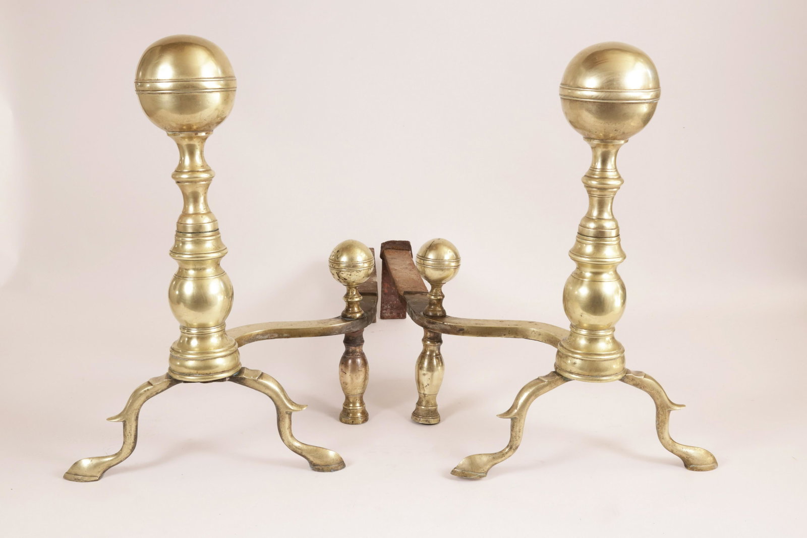 Pair of Period Brass Boston Ball Top Andirons with Matching Log Stops, 19th Century: Pair of Period Brass Boston Ball Top Andirons with Matching Log Stops, 19th Century, on arched spurred legs ending in slipper feet Height 17 in. Depth 22 in.