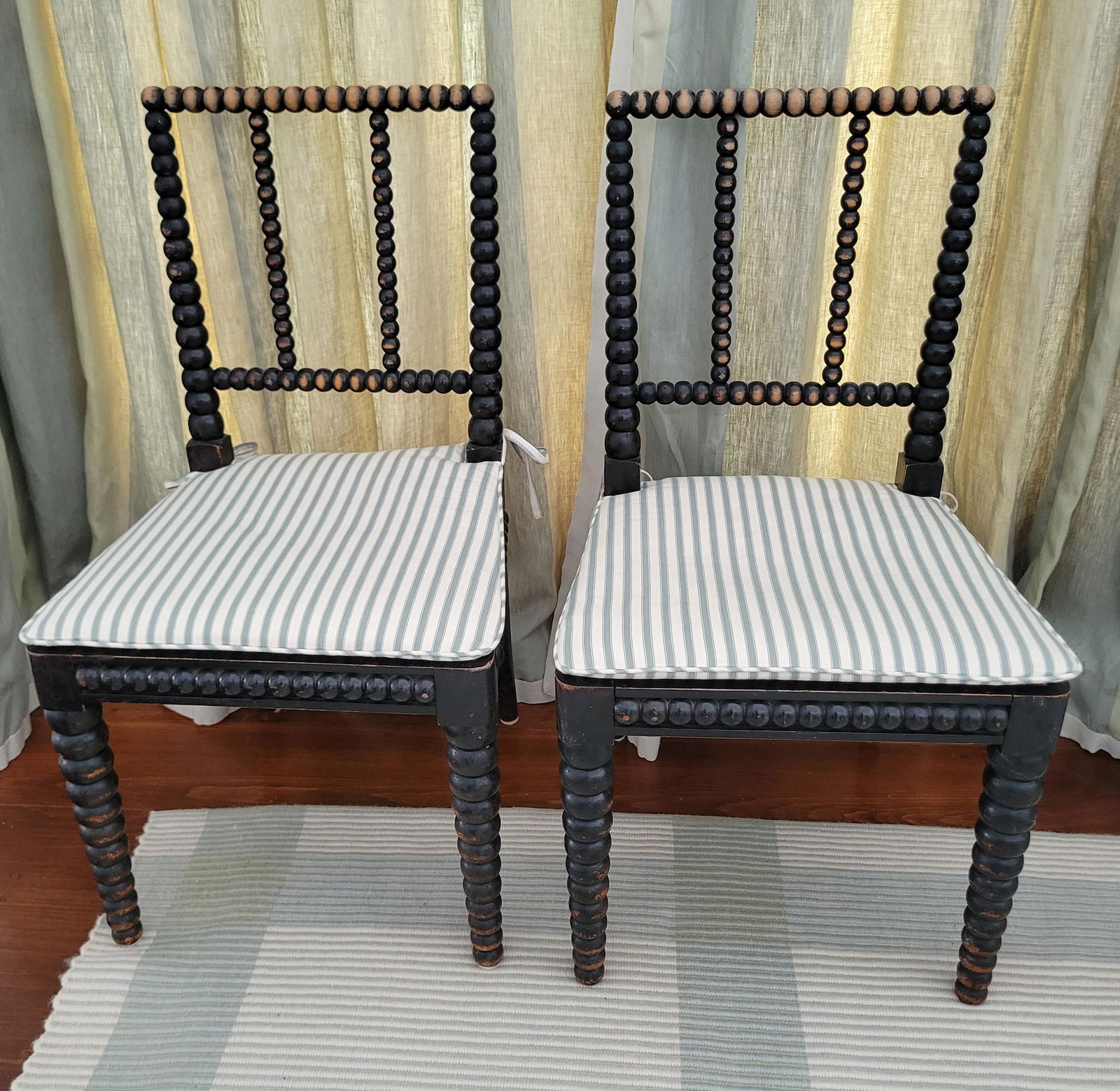 Pair of English Bobbin-Turned Ebonized Beechwood Side Chairs, 19th Century: Pair of English Bobbin-Turned Ebonized Beechwood Side Chairs, 2nd Quarter of 19th Century, with caned seat, loose pad cushions Height 34 in. Width 18.5 Depth 17 in. Seat Height 17 in.