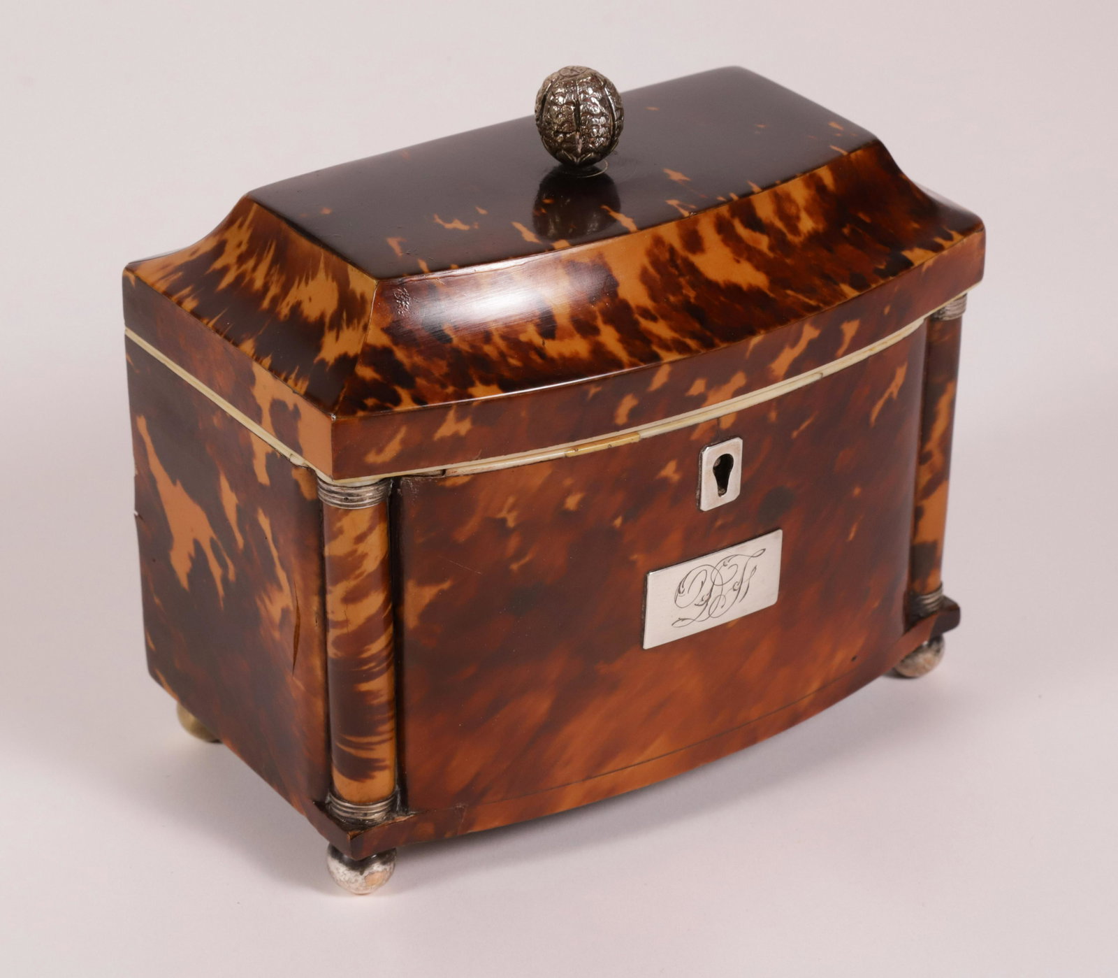 Petite British Regency Antique Tortoiseshell Double Compartment Tea Caddy, 19th Century: Petite British Regency Antique Tortoiseshell Tea Caddy, 19th Century, bow-fronted oblong form with engaged corner columns; cavetto molded hinged lid, silver metal mounts and plaquette engraved with in