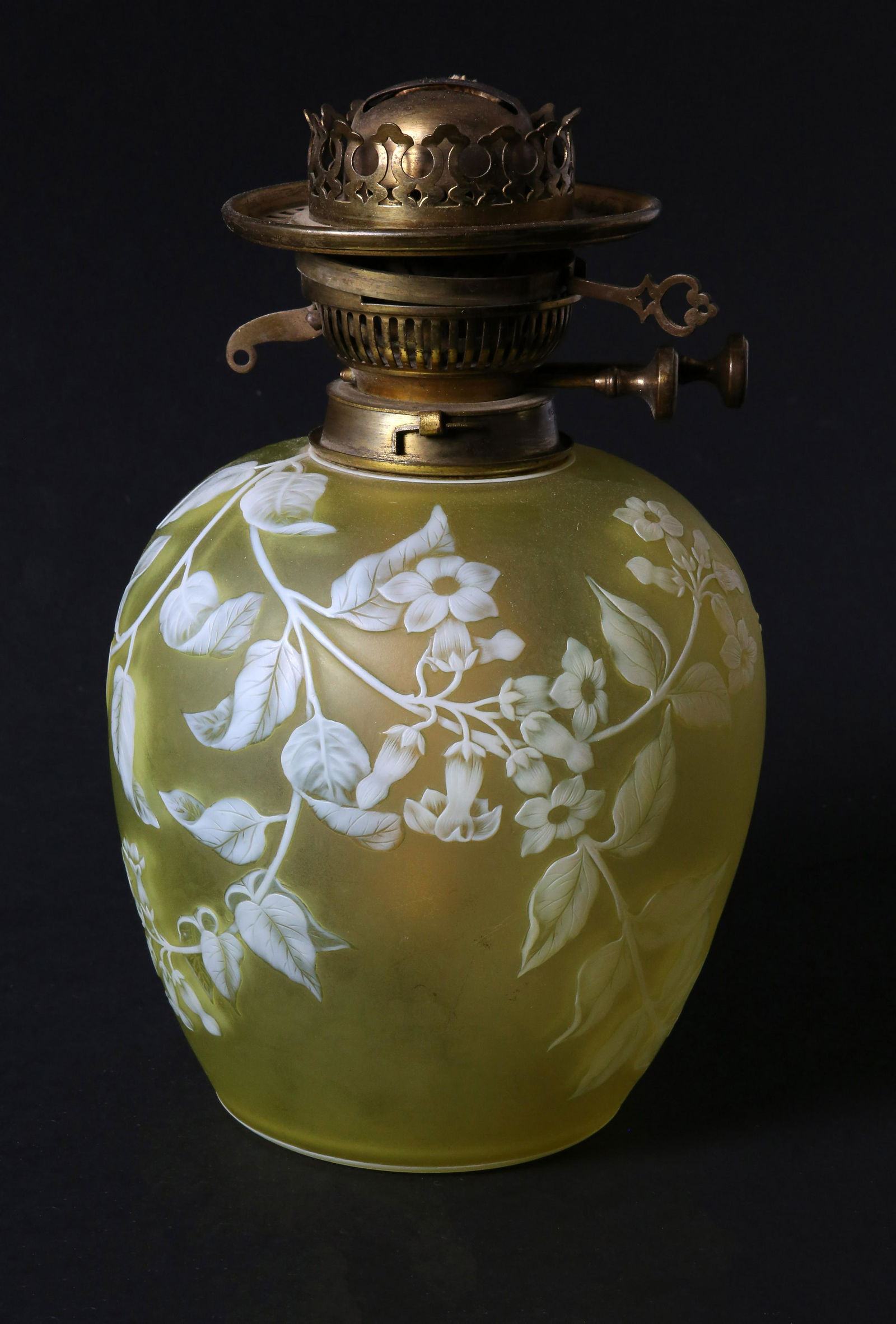 Signed Thomas Webb and Son Cameo Glass Kerosene Lamp: Signed Thomas Webb and Son Cameo Glass Kerosene Lamp, white cut to yellow glass in a floral vine design, with original brass front, signed upon the base "Thos. Webb and Son Cameo" Height 10.5 in. Diam