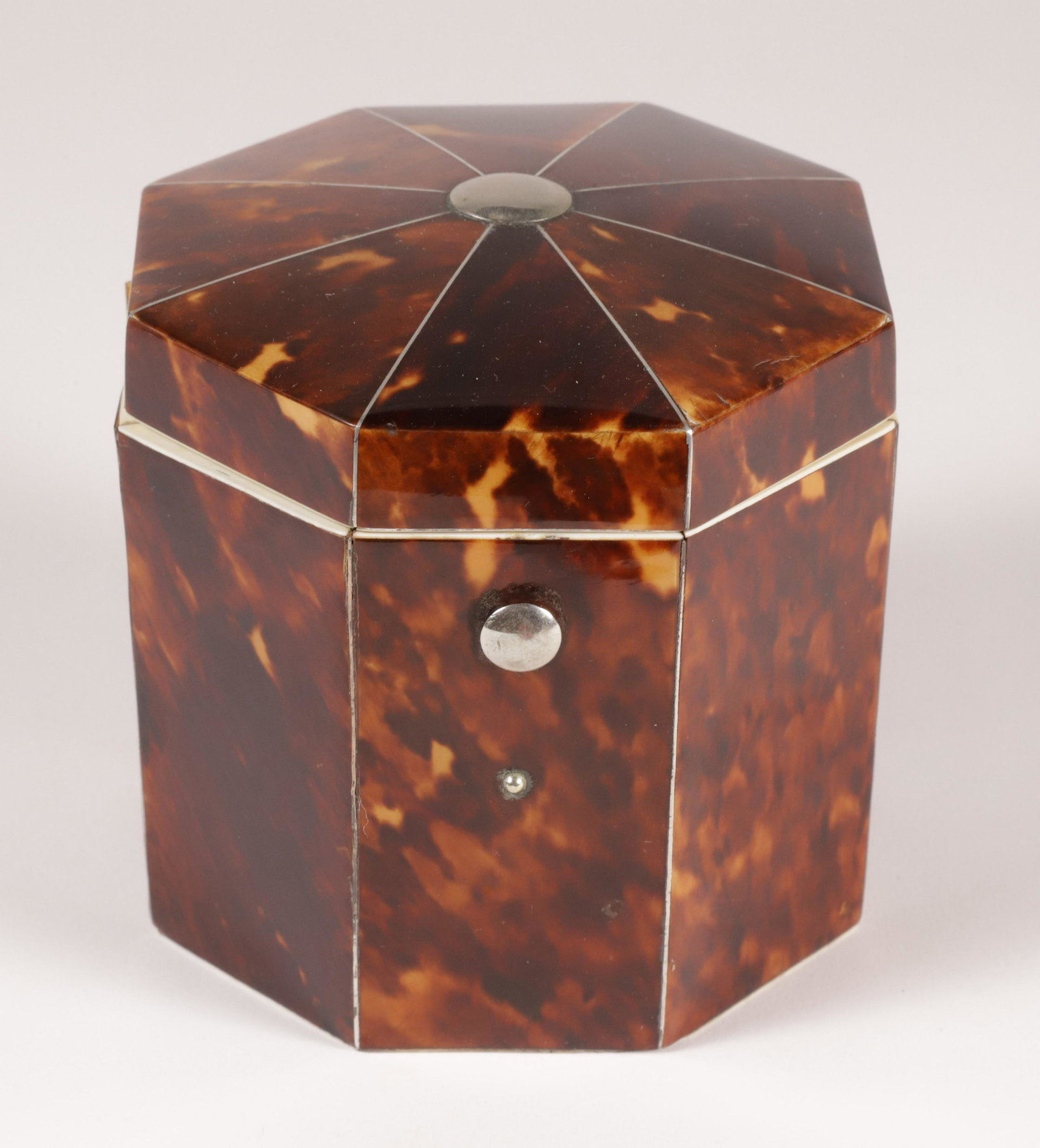 British Regency Antique Tortoiseshell Octagonal Tea Caddy, circa 1830: British Regency Antique Tortoiseshell Octagonal Tea Caddy, circa 1830 with hinged cover opening to lidded interior; silver metal mounts and stringing, bone details Height 4 in. Width 4 in. Depth 4 in.