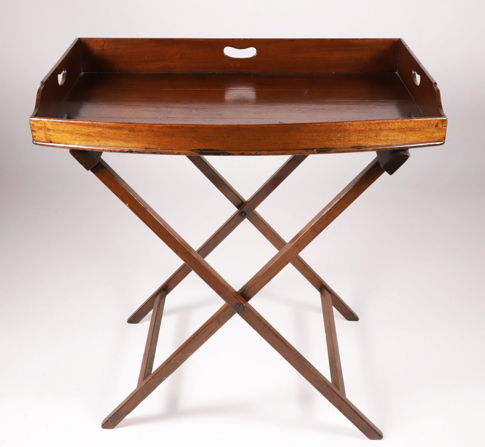 English Georgian Mahogany Bow Front Butler's Tray on Folding Stand: English Georgian Mahogany Bow Front Butler's Tray on Folding Stand Height 32 in. Width 32.5 in. Depth 23 in.