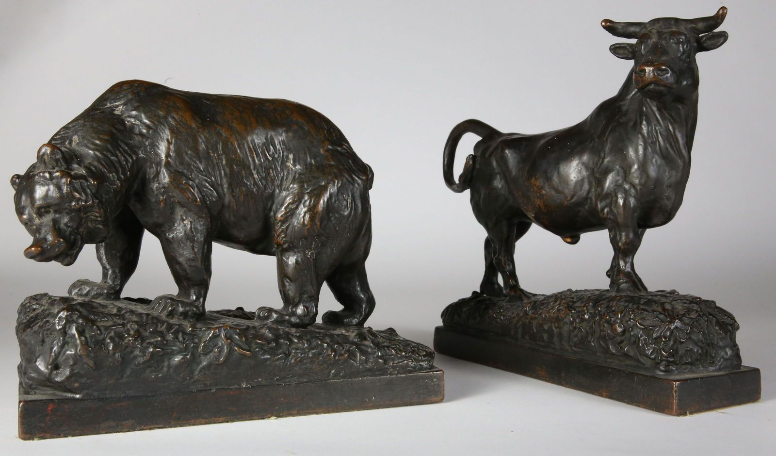 Pair of Paul Herzel Bronze-Clad Bear and Bull Bookends, circa 1922: Pair of Paul Herzel (1876-1956) Bronze-Clad Bear and Bull Bookends, circa 1922, signed and dated Paul Herzel, 1922; the bear numbered 170 on plinth, made by Pompeian Bronze Clad Mfg. Company Heights 6