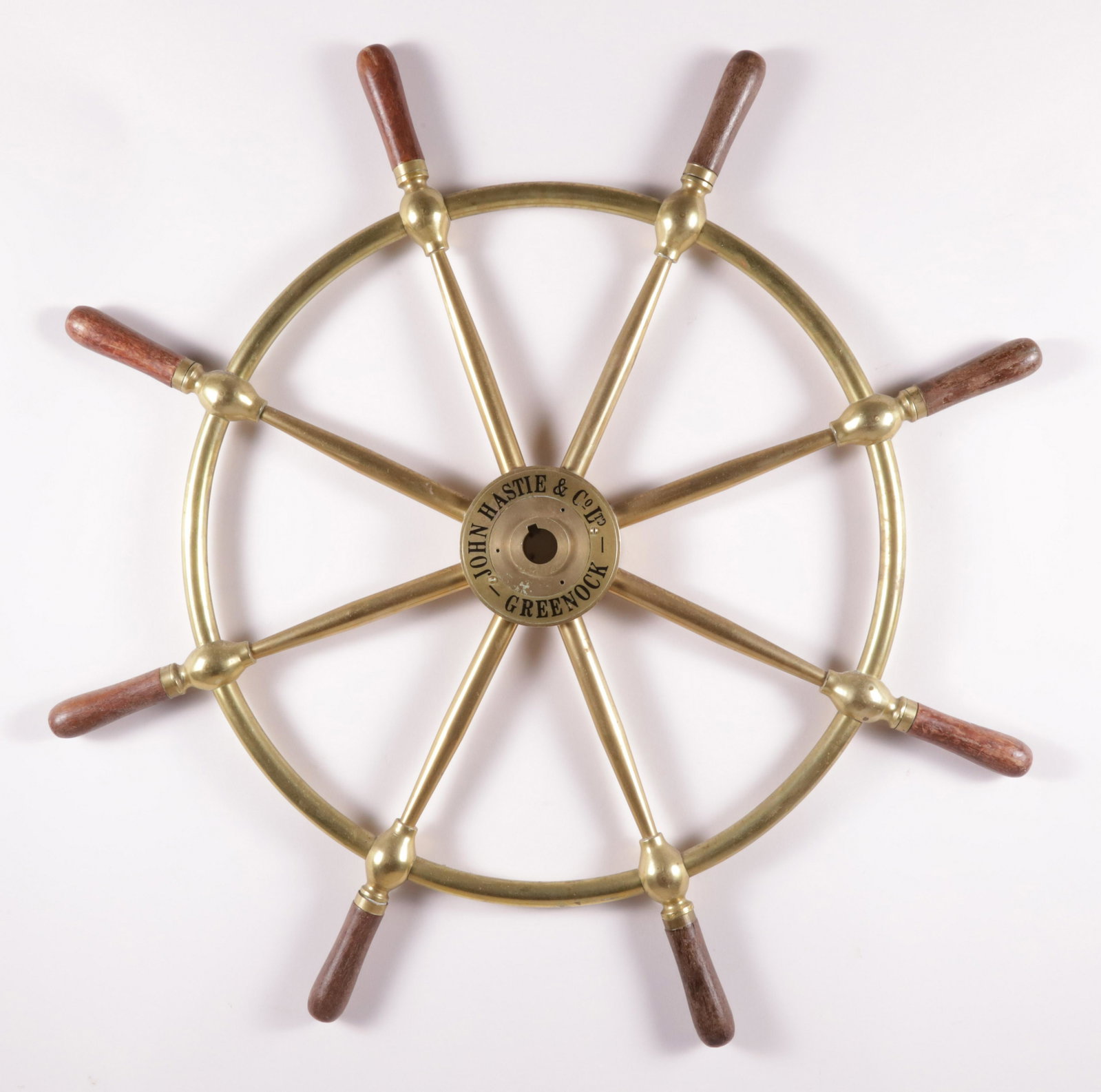Brass Ship's Wheel "John Hastie & Co., Ltd, Greenock": Brass Ship's Wheel "John Hastie & Co., Ltd, Greenock", with eight mahogany grips, signed on the brass hub John Hastie & Co., Ltd, Greenock Diameter 30 in.