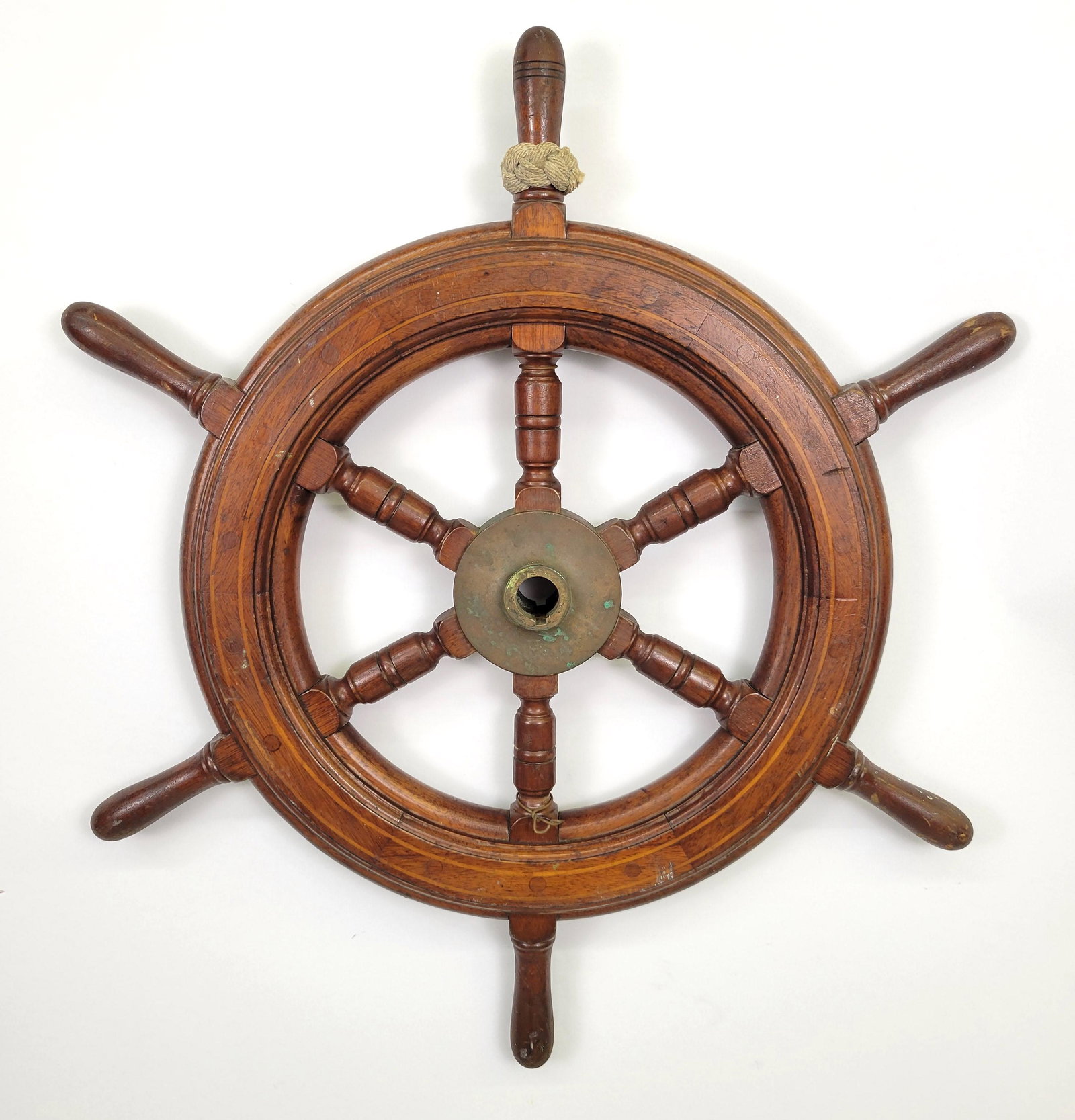 Antique American Inlaid Mahogany Yacht Ship's Wheel: Antique American Inlaid Mahogany Yacht Ship's Wheel, with brass hub, concentric inlaid lines, 12 O'clock handle marked with fancy knotwork. Diameter 25 in.