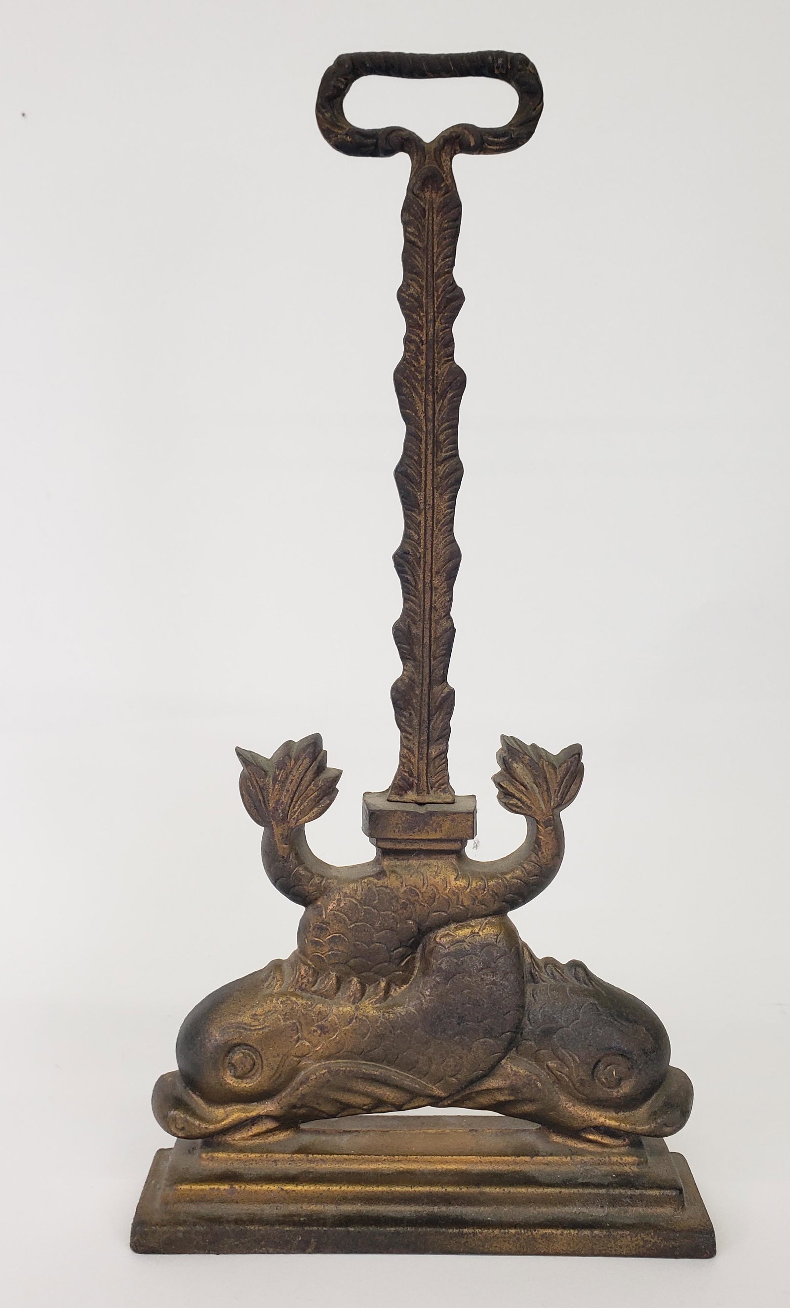 Antique English Cast Iron Figural Dolphin Doorstop: Antique English Cast Iron Figural Dolphin Doorstop, with double flanking sea serpent base with elongated handle. Height 18 in. Width 9 in. Depth 2.25 in.