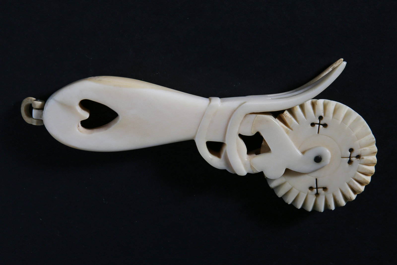 Whaleman Made Carved Heart Handled Pie Crimper, 19th Century: Whaleman Made Carved Heart Handle Pie Crimper, 19th Century, carved from a single piece of antique whale ivory with pinned zigzag wheel, two-tine fork, hinged hanging loop. Note: one fork tine glued L