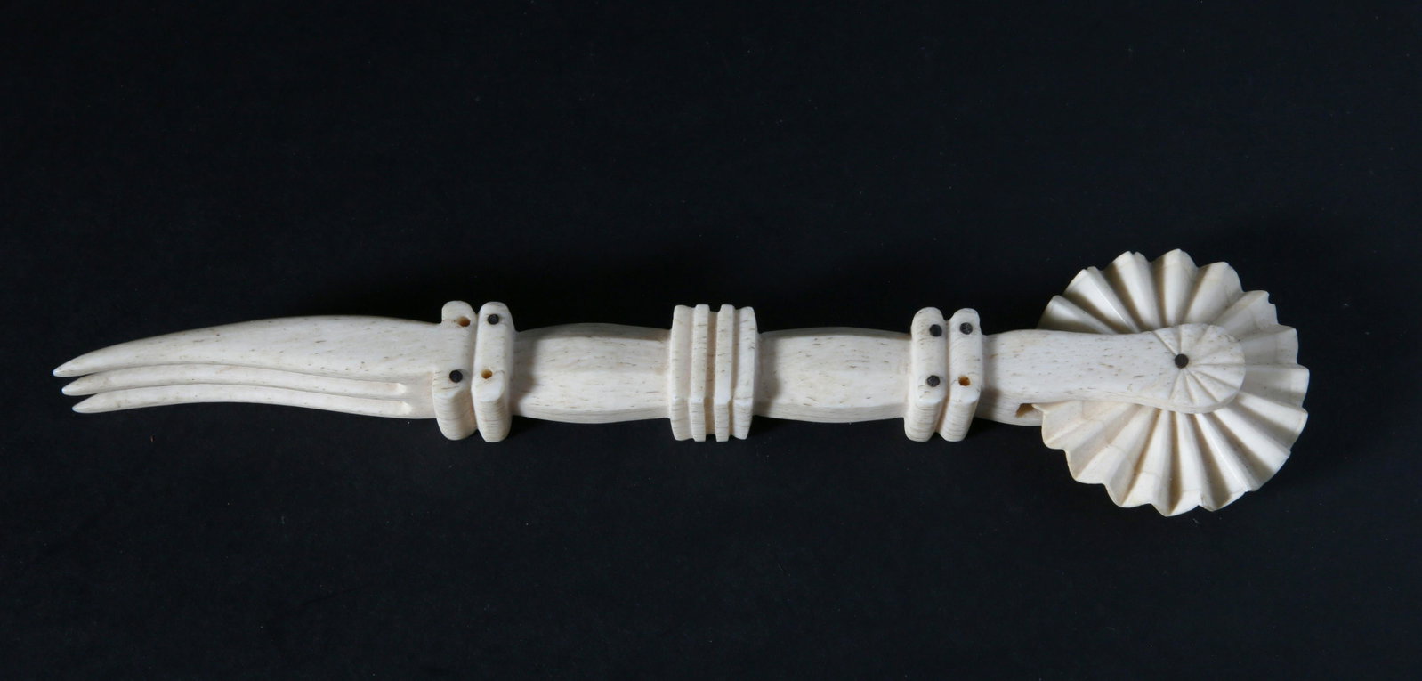 Whaleman Made 3-Tine Fork Pie Crimper, 19th Century: Whaleman Made 3-Tine Fork Pie Crimper, 19th Century, carved from a single piece of whalebone with pinned antique whale ivory zigzag wheel Length 8 in. Provenance: The Estate of Stephen Weinroth, Nantu