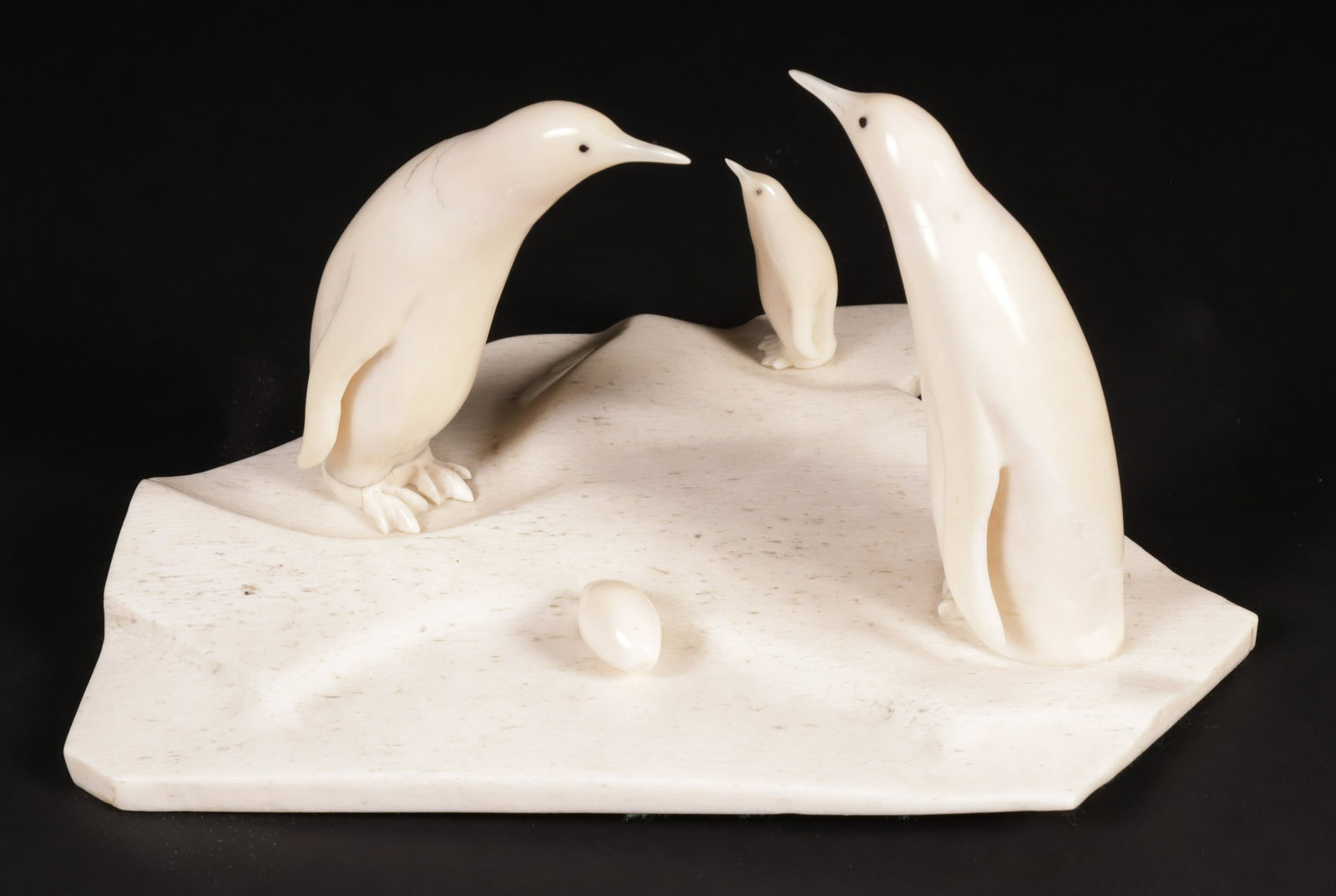 Carved Bone Penguin Family: Carved Bone Penguin Family on Bone Plinth Height 4.5 in. Width 8.5 in. Depth 7 in. Provenance: The Estate of Stephen Weinroth, Nantucket, Massachusetts
