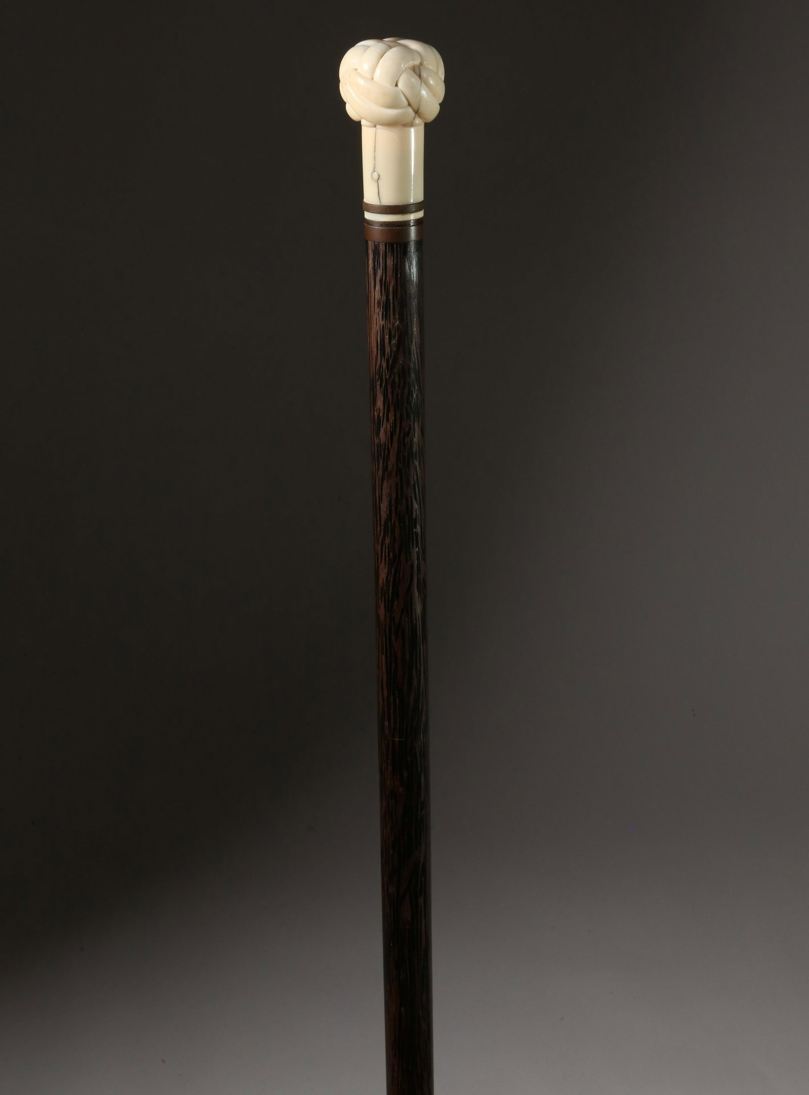 Whaleman Made Turk's Knot Walking Stick, 19th Century: Whaleman Made Turk's Knot Walking Stick, 19th Century, carved antique whale ivory Turk's knot grip with four spacers upon a tapering tropical wood shaft ending in a metal ferrule Length 34 in. Provena