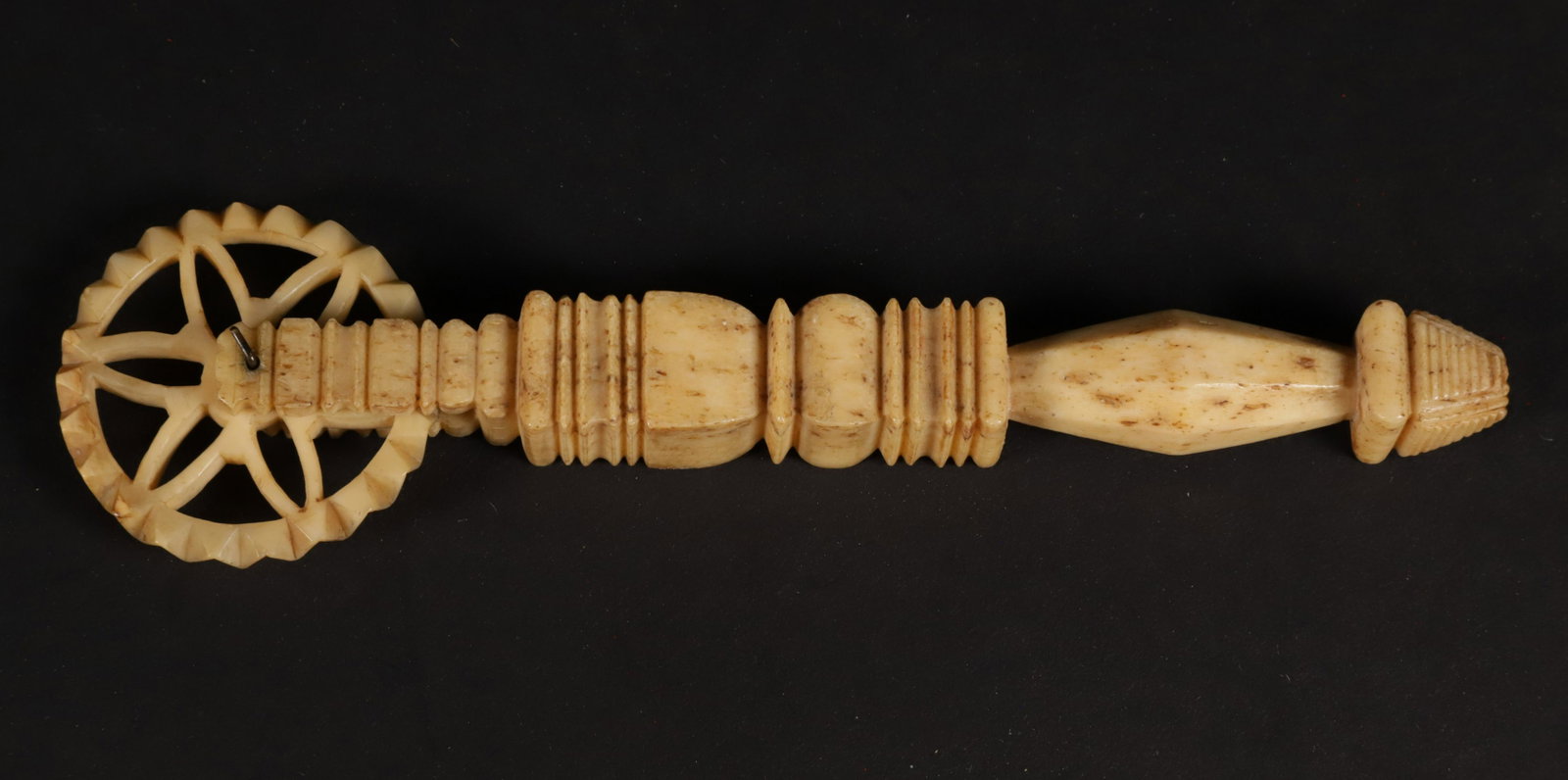 Carved Antique Whalebone Diminutive Pie Crimper, mid 19th Century: Carved Antique Whalebone Diminutive Pie Crimper, mid 19th Century, open spoke and zigzag wheel on a paneled and reeded grip Length 5.75 in.