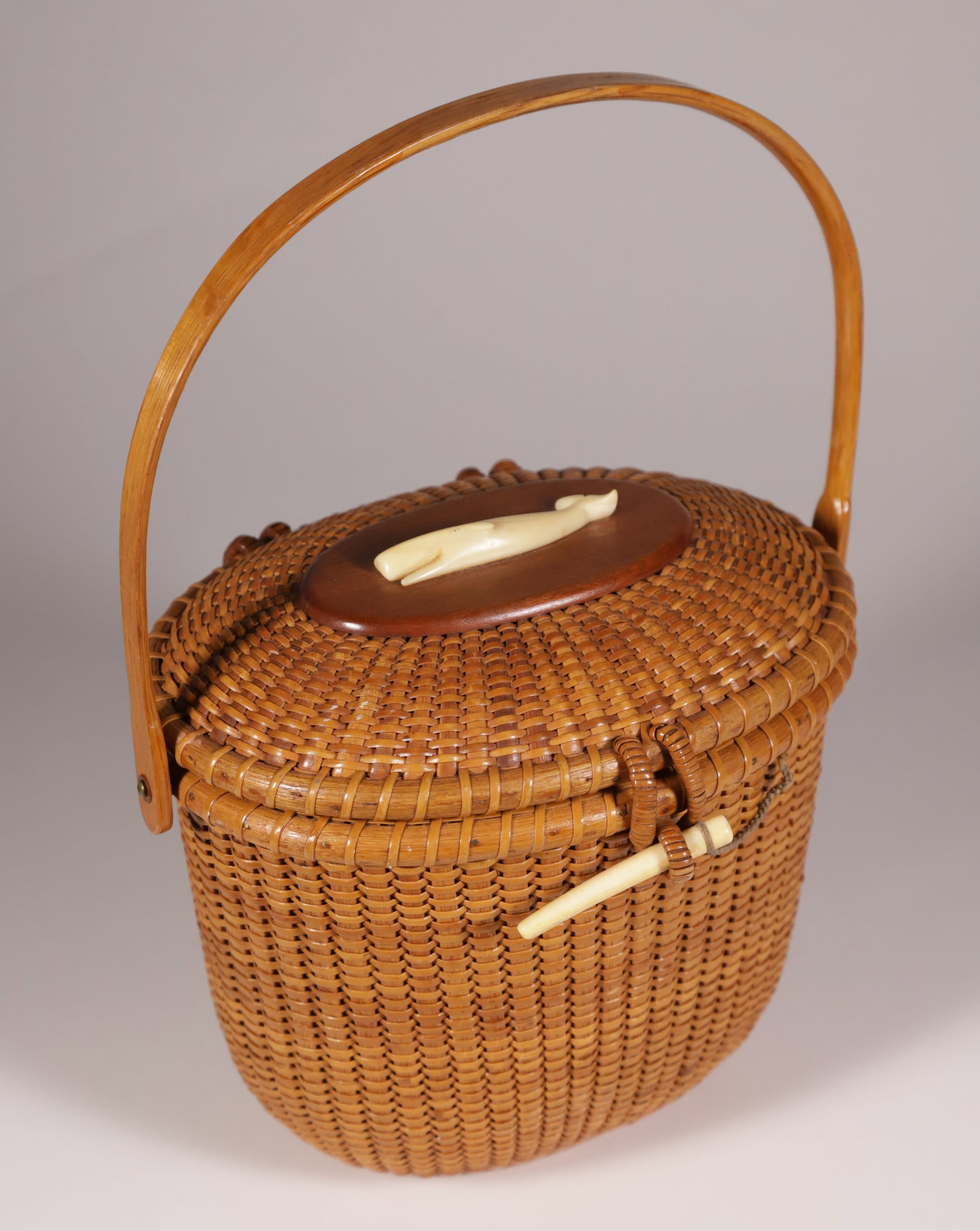 Stephen Gibbs Nantucket Friendship Basket Oval Form with Charlie Sayle Carved Whale: Stephen Gibbs (1896-1974) Nantucket Friendship Basket, oval form, with Charlie Sayle carved whale on lid and branded underneath "S.Gibbs Maker, Nantucket, Mass." Height 6.5 in. Width 7.5 in. Depth 6 i