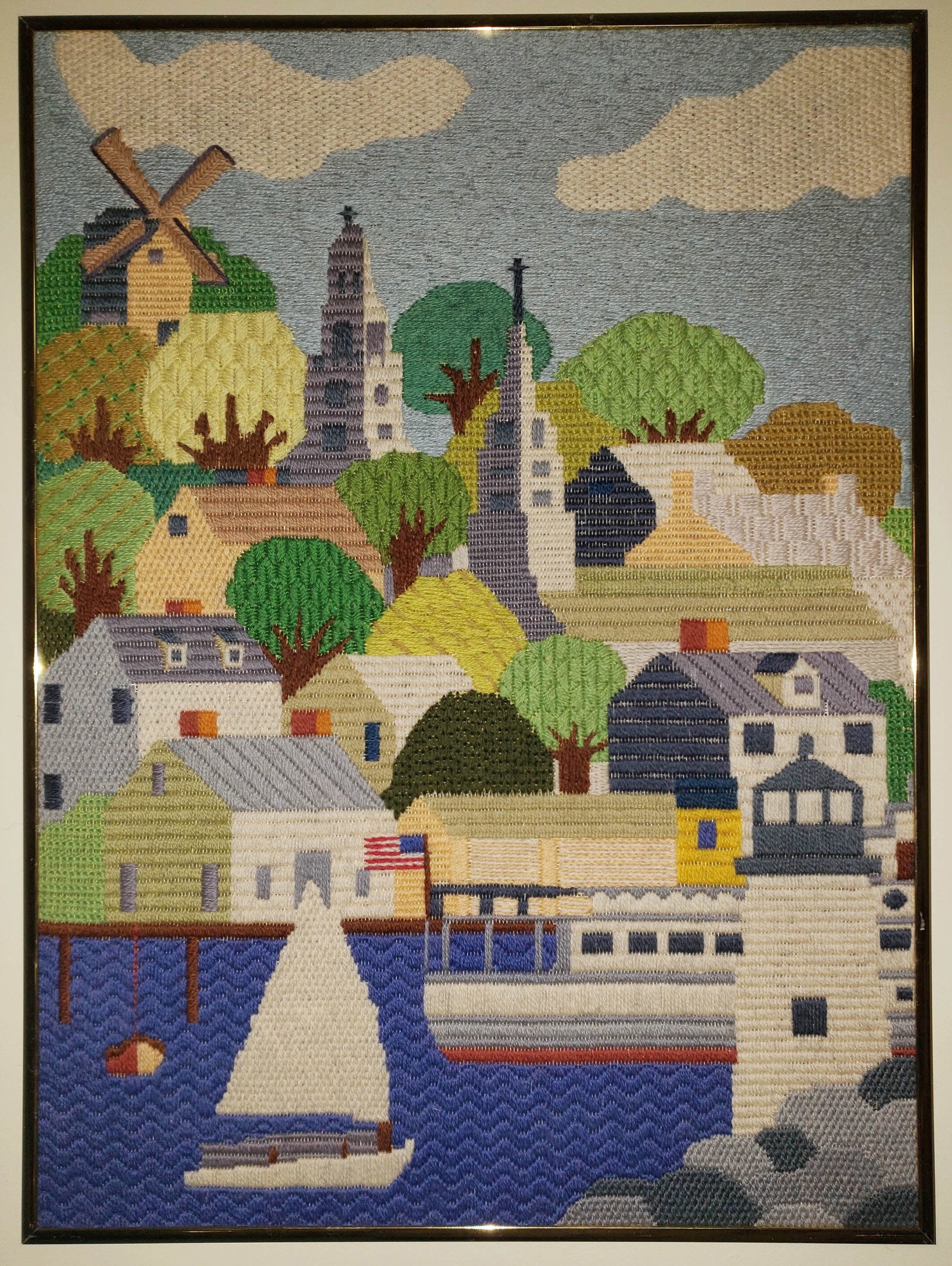 Vintage Erica Wilson Nantucket Harbor Needlepoint Picture: Vintage Erica Wilson Nantucket Harbor Needlepoint Picture, depicting various island landmarks, The Old Mill, Brant Point Lighthouse, and the Unitarian Church clock tower. Overall 24 in. x 17.75 in.