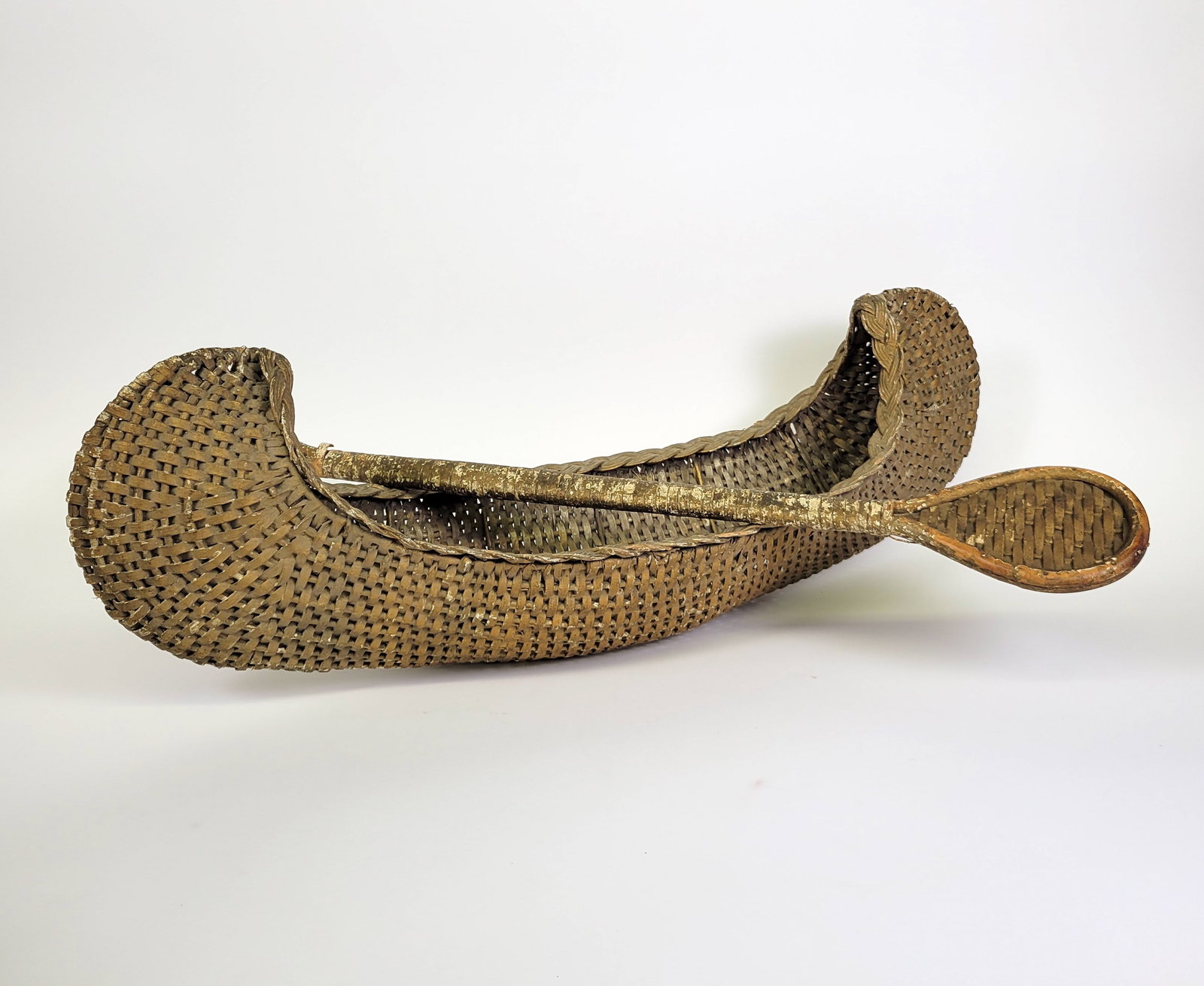 Antique Miniature Painted Woven Wicker Folk Art Canoe and Paddle: Antique Miniature Painted Woven Wicker Folk Art Canoe and Paddle, circa 1880, doll size double ended canoe, tightly woven with fancy twist woven gunwales, with matching double ended paddle. Length 29