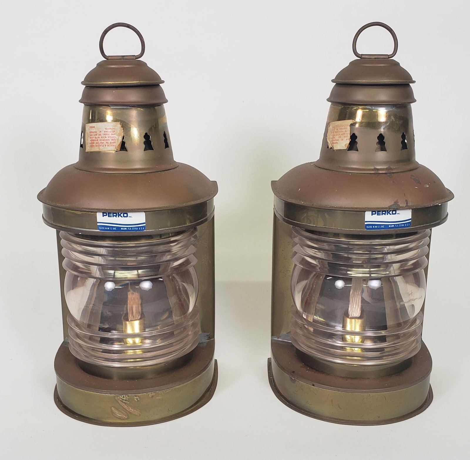 Pair of Vintage Brass Perko Ship's Light Lanterns: Pair of Vintage Brass Perko Ship's Light Lanterns, with original oil burners and labels. Height 13 in. Width 6.25 in. Depth 8.25 in.