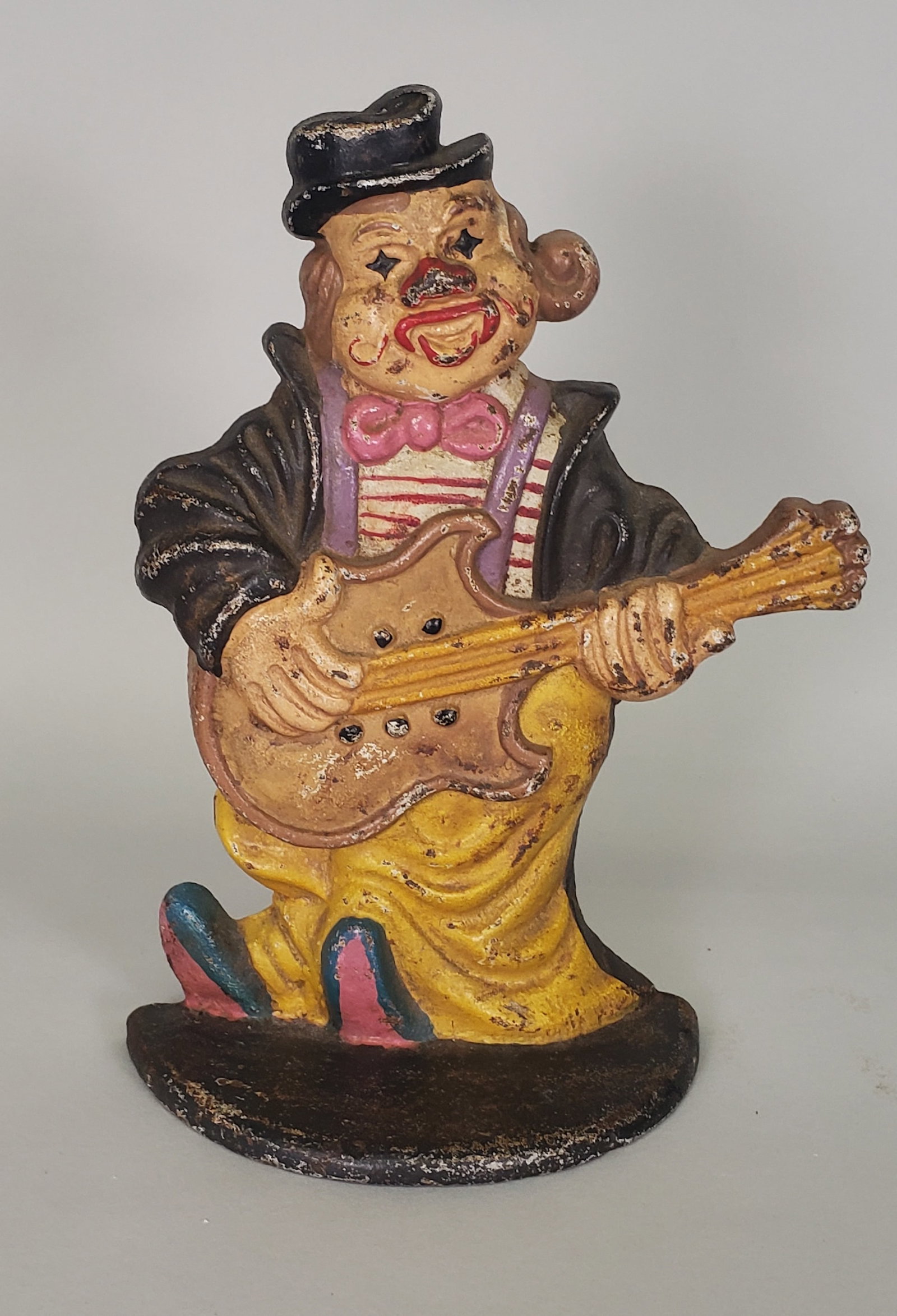 Vintage Painted Cast Iron Minstrel Clown Figural Doorstop: Vintage Painted Cast Iron Minstrel Clown Figural Doorstop Height 10 in. Width 7.25 in. Depth 3.25 in.