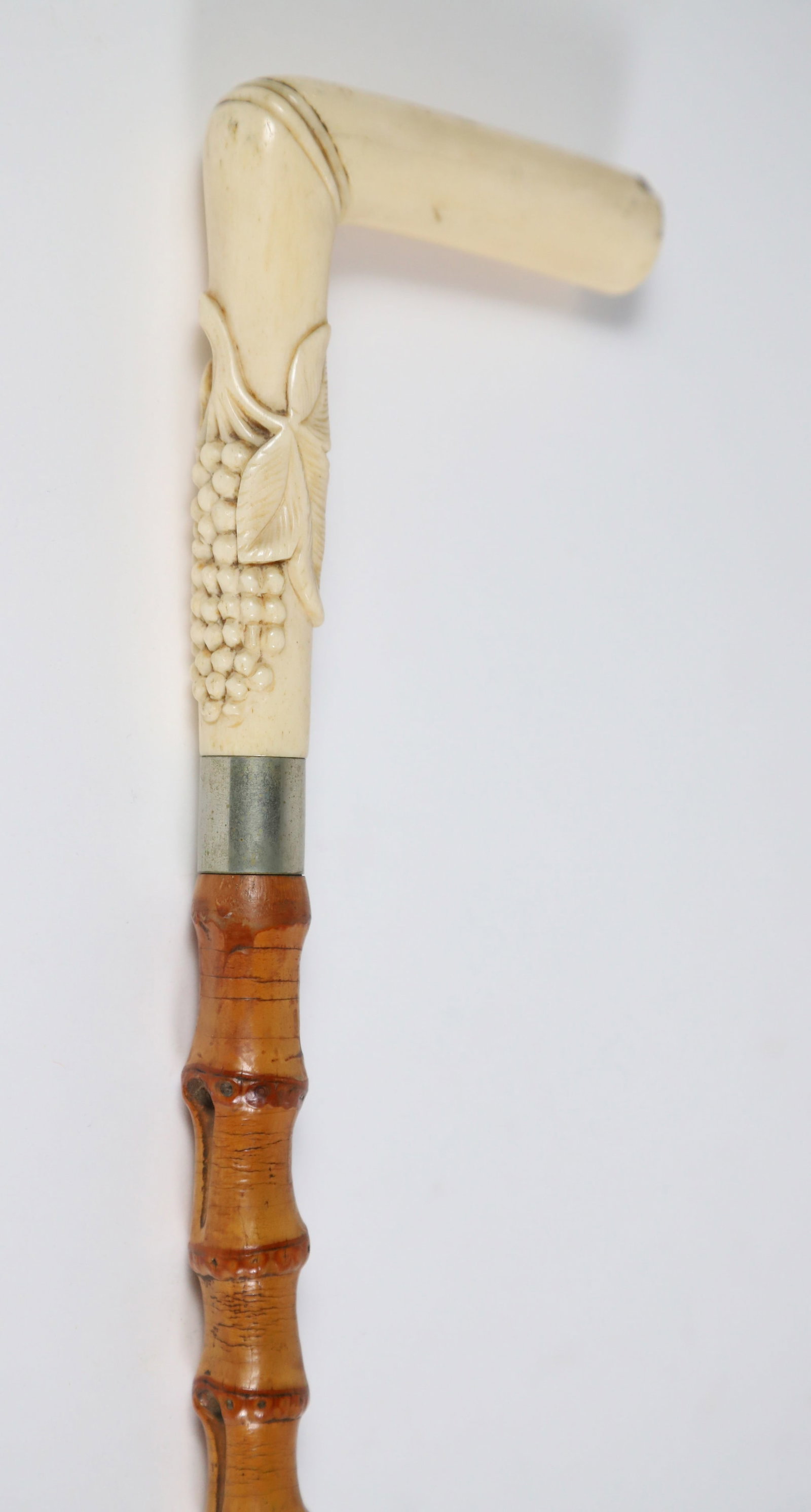 Carved Bone L-Grip Grape Cluster Cane, 19th Century: Carved Bone L-Grip Grape Cluster Cane, 19th Century, on natural bamboo shaft, bone ferrule Length 34 in.