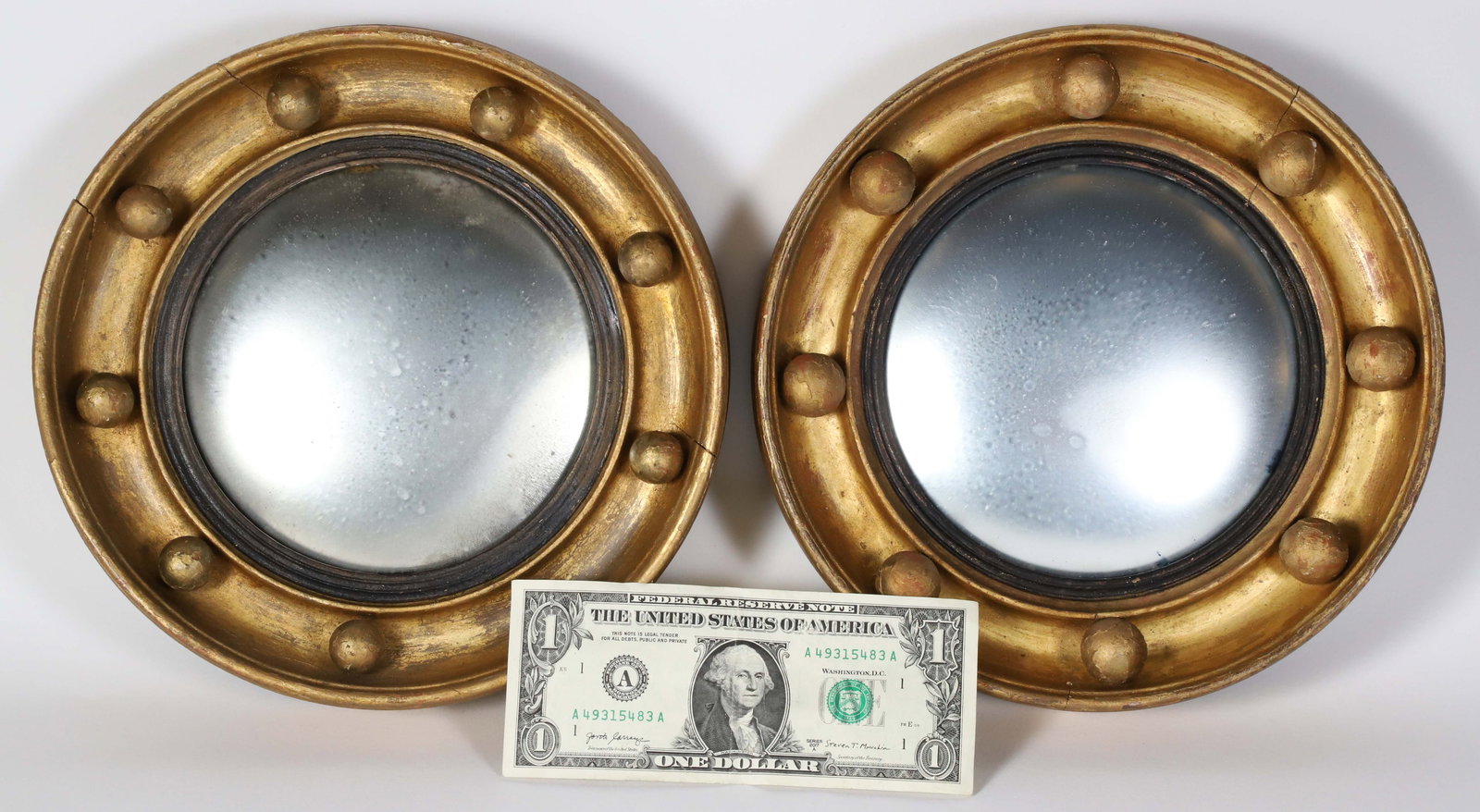 Pair of Regency Bull's Eye Mirrors, early 19th Century: Pair of Regency Bull's Eye Mirrors, early 19th Century, convex plate in circular molded giltwood frame applied with spherules and with ebonized liner, retains original rings for hanging Diameter 9 in.