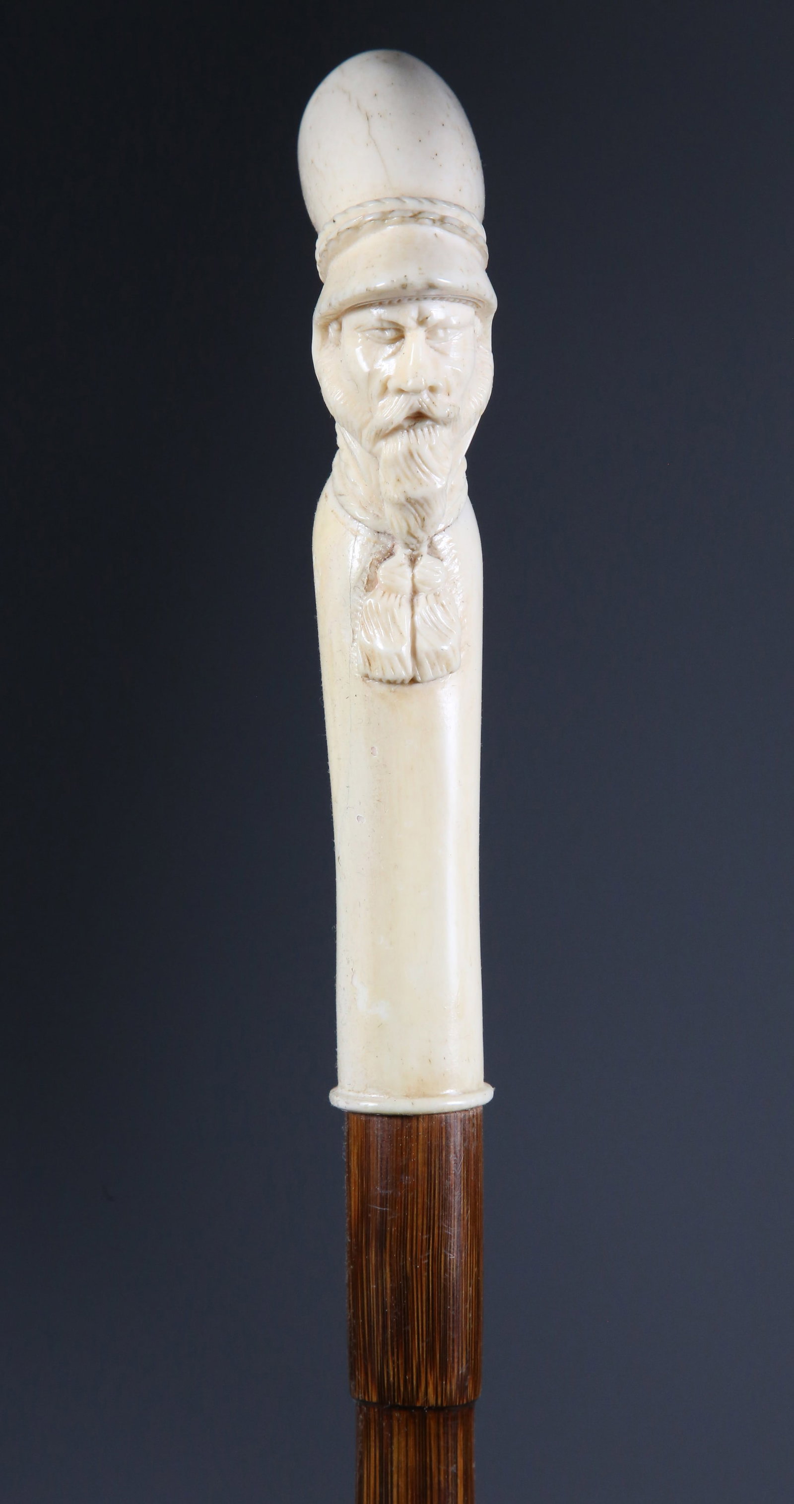 Carved Bone Leprachaun Portrait Cane, 19th Century: Carved Bone Leprachaun Portrait Cane, 19th Century, on bamboo shaft ending in a brass and iron ferrule Length 37.75 in. Provenance: The Estate of Stephen Weinroth, Nantucket, Massachusetts