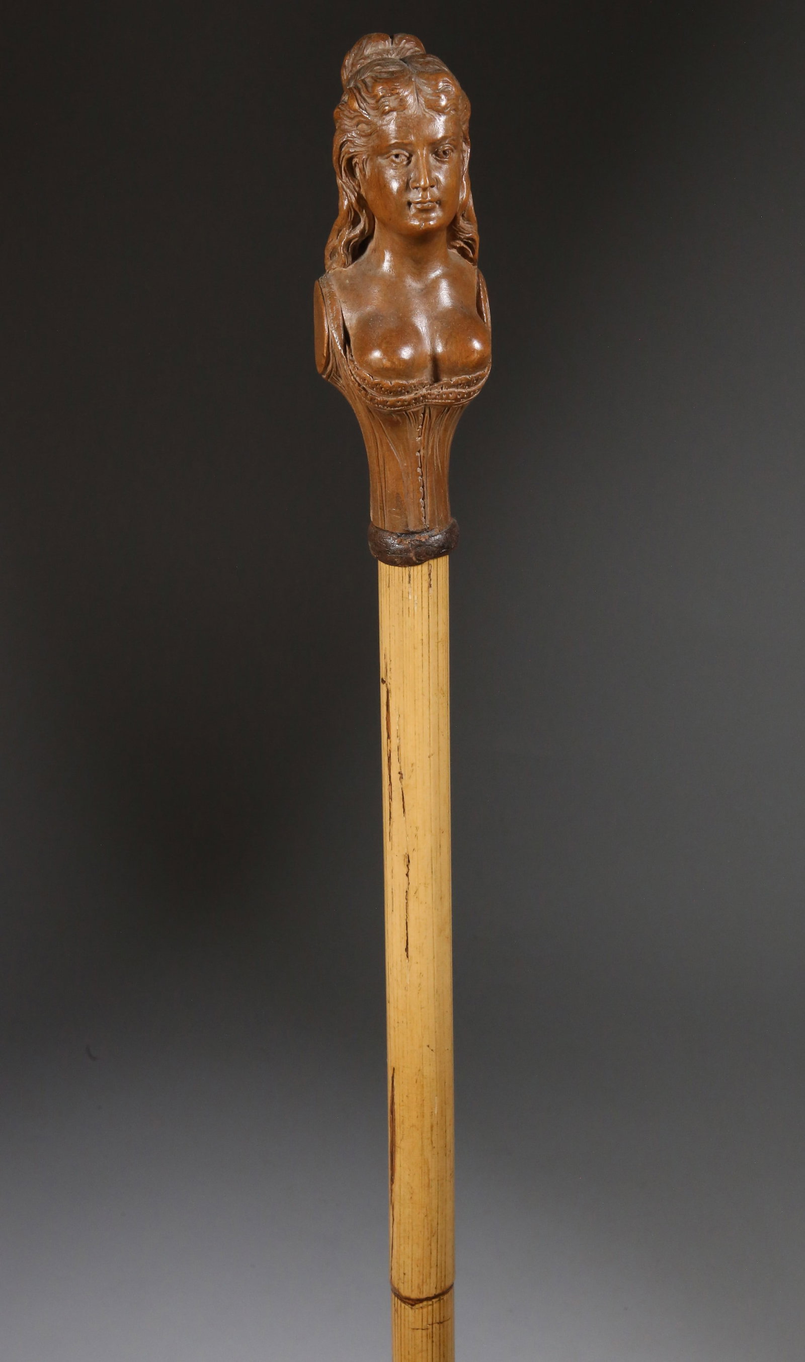 Finely Carved Wood Woman Portrait Walking Stick, 19th Century: Finely Carved Wood Woman Portrait Walking Stick, 19th Century, portrait of a busty woman with flowing hair and wearing a corset grip, bamboo shaft ending in a horn ferrule Length 36 in. Provenance: Th