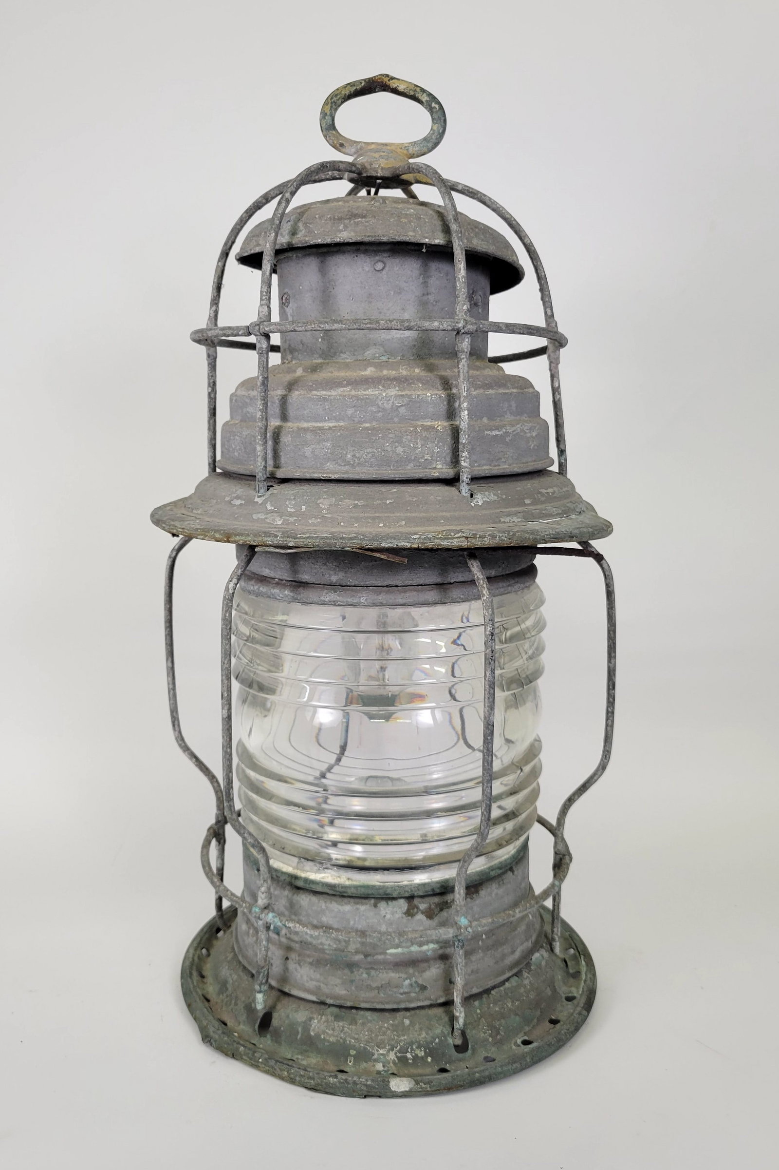 United States Lighthouse Service Post Lantern: United States Lighthouse Service Post Lantern, circa 1900, with large clear Fresnel lens, heavy old gray patina and paint on copper and brass lantern body, electrified. Height 24 in. Width 10.5 in.