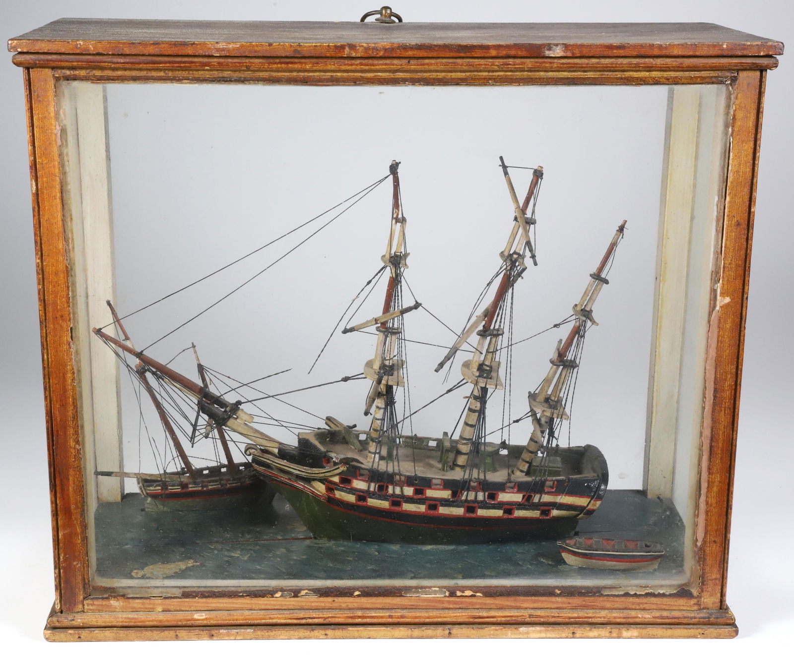 Antique Three-Mast Ship Model in Case, 19th Century: Antique Three-Mast Ship Model in Case, 19th Century,?folk art rendition with three vessels on carved water Approximate size Height 13 in. Width 16 in. Depth 7 in.