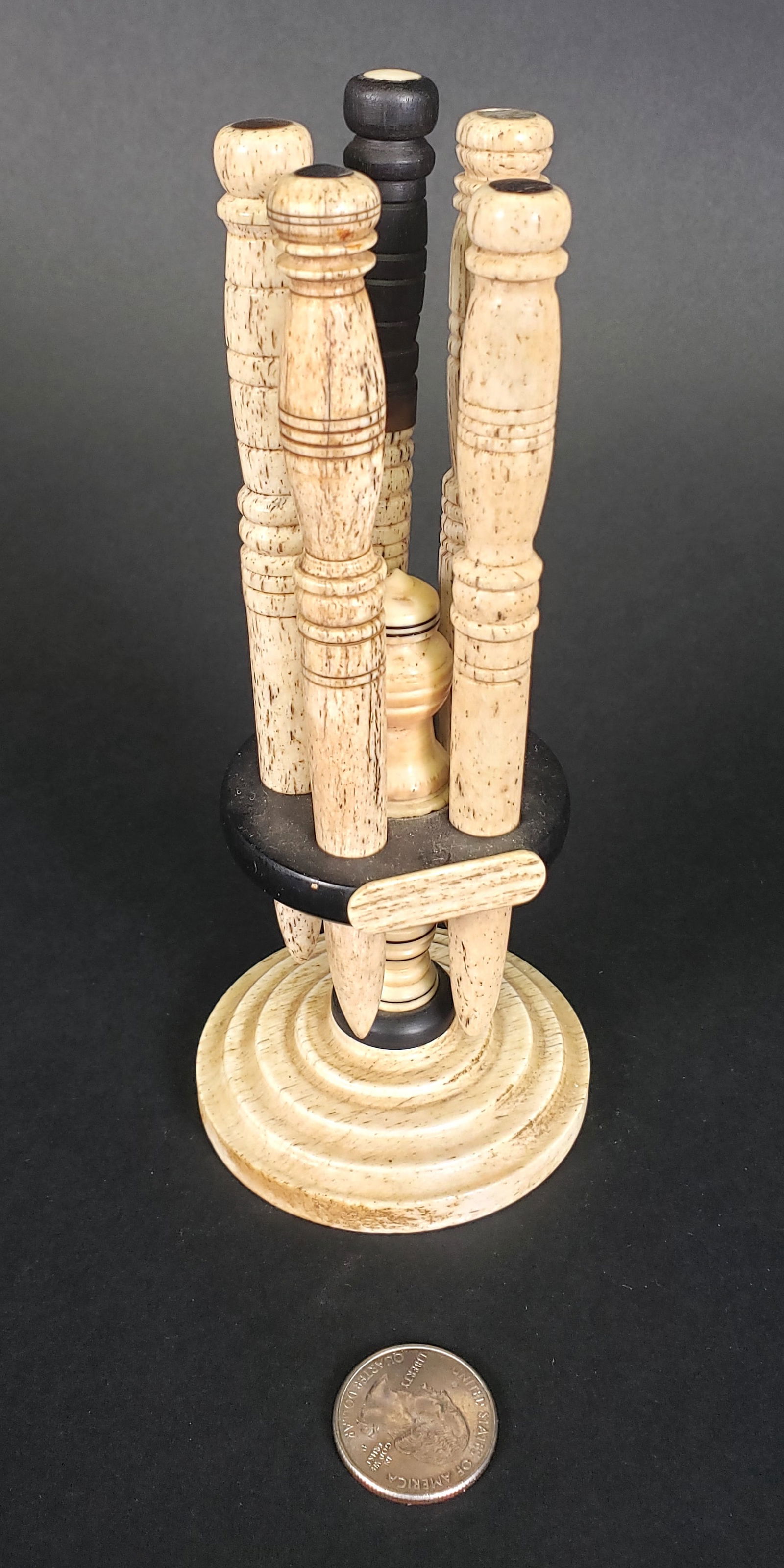 Sailor Made Antique Whalebone and Ebony Bodkins and Caddy, 19th century: Sailor Made Antique Whalebone and Ebony Bodkins and Caddy, 19th century, comprising of five turned oversized bodkins and turned standard carrying caddy comprising of five conforming carved holes and a