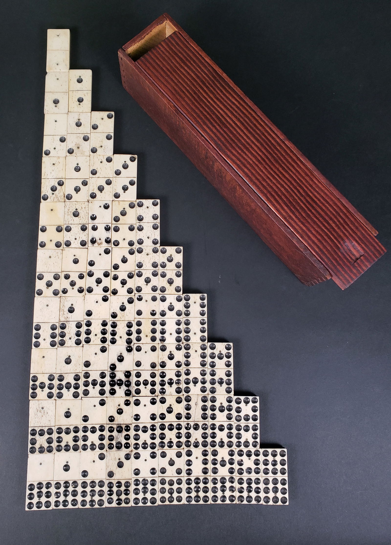 Complete Set of Sailor Made Antique Bone and Ebony Double Nine Dominoes, 19th Century: Complete Set of Sailor Made Antique Bone and Ebony Double Nine Dominoes, 19th Century, 55 tiles, each double pinned with brass tacks, in fitted pine dovetailed slide top box. Tile 1 in. x 2 in. Box He