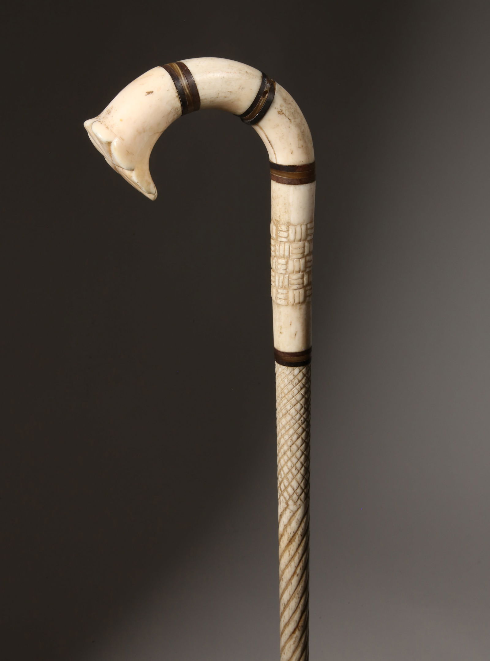 Whaleman Made Antique Whale Bone and Baleen C-Grip Cane, circa 1860: Whaleman Made C-Grip Cane, circa 1860, sectional antique whalebone and baleen C-grip on a whalebone shaft with basket-weave carved section above a hatch carved and rope turned shaft Length 34 in. Prov