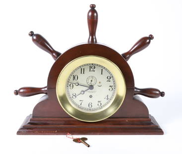Chelsea Clock Company, Boston U.S.A. 5.5 in. Dial Mantel Clock: Chelsea Clock Company, Boston U.S.A. 5.5 in. Dial Mantel Clock, retailed by Upsom Walton Co. Cleveland, mounted on a custom mahogany partial ship's wheel Height 13.5 in. Width 17 in. Depth 3.5 in.