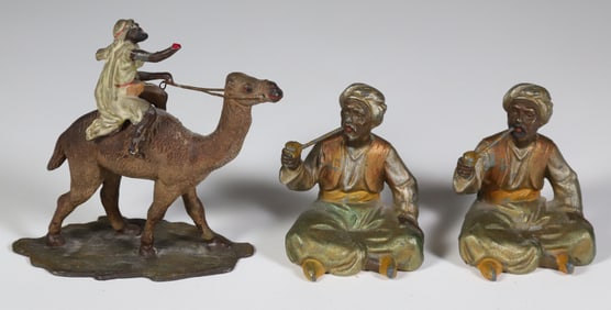 Cold Painted Bronze Figure of a Bedouin Riding a Camel, Together with Spelter Arabs, circa 1900