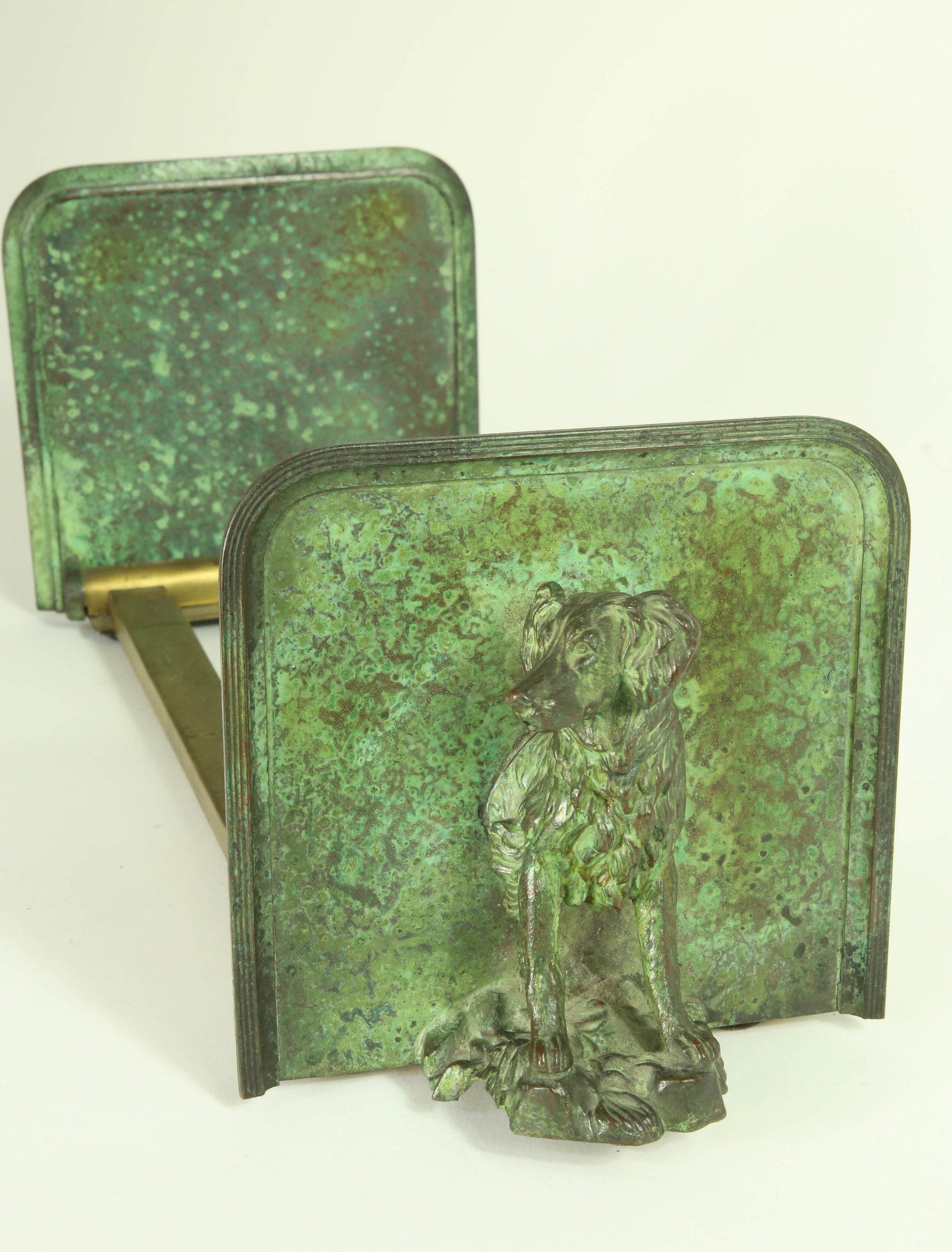 Green Patina Dog Bookends, 20th Century: Green Patina Dog Bookends, 20th Century, half-body standing setters on rock formations with brass adjusting rails; the dogs face in opposite directions Plates: Height 5.25 in. Width 5.25 in. Length Cl