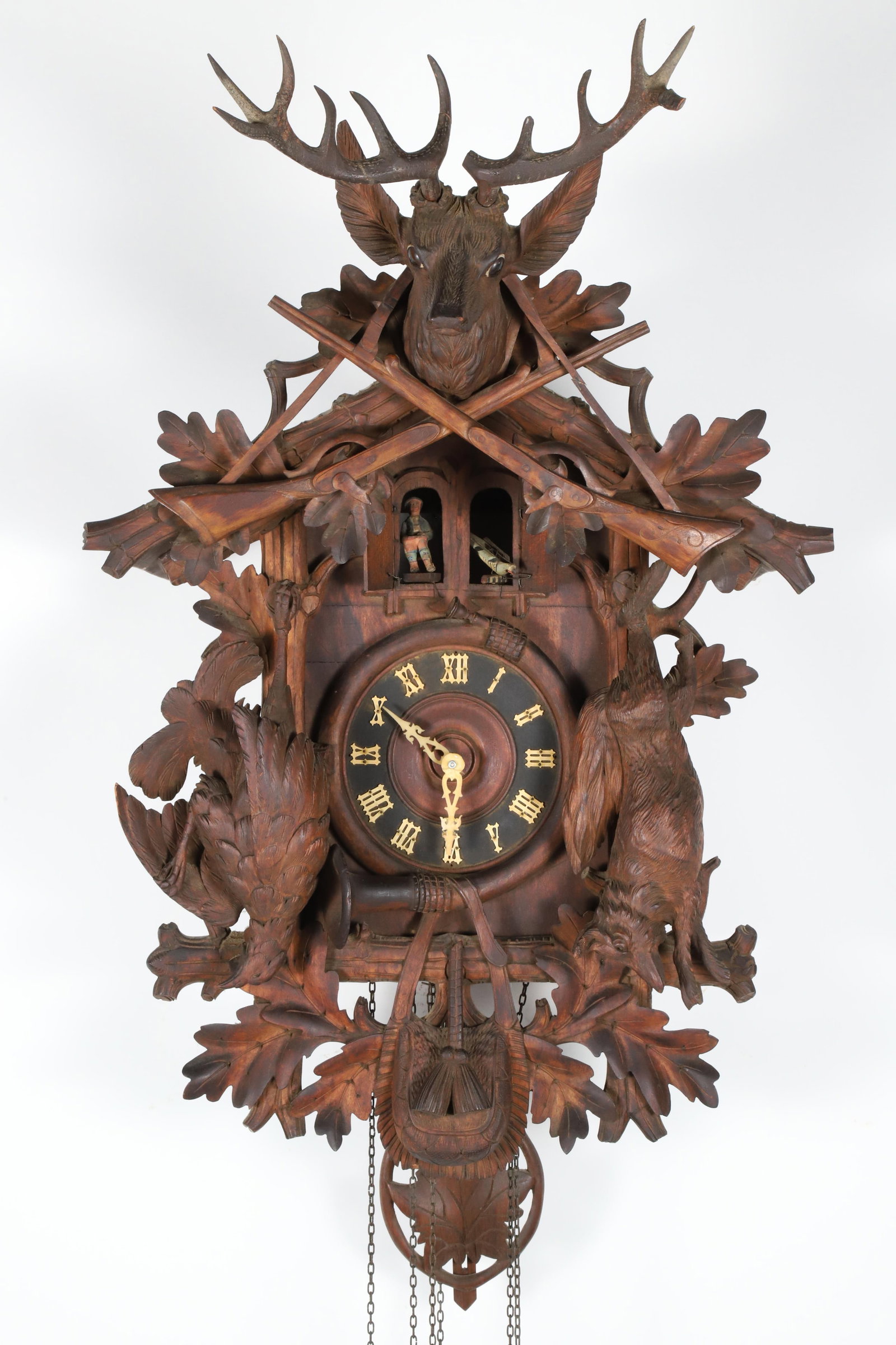 Black Forest Carved Cuckoo Clock, 19th Century: Black Forest Carved Cuckoo Clock, 19th Century with carved game, horn, rifle and stag decorations Height 32 in. Width 21 in. Depth 20 in.