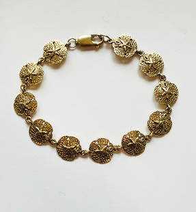14k Yellow Gold Sand Dollar Bracelet: 14k Yellow Gold Sand Dollar Bracelet, stamped 14k RA Length 7 in. 7.61 dwt Provenance:The Estate of Jean M. Valerio, Wellesley, Massachusetts