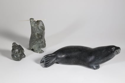 Three Eskimo Stone Carvings Depicting a Seal and Two Eskimos