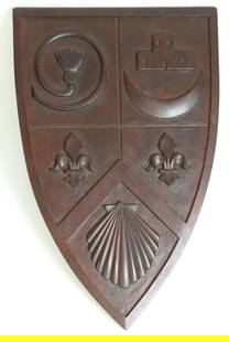 Bellamy Coat of Arms in Carved Mahogany, circa 1949: Carved Mahogany Bellamy Coat of Arms, circa 1949, shield form plaque, carved on reverse: Bellamy Arms with hand written paper label: Carved by John Haley Bellamy of Kittery Point, ME, given to Joseph